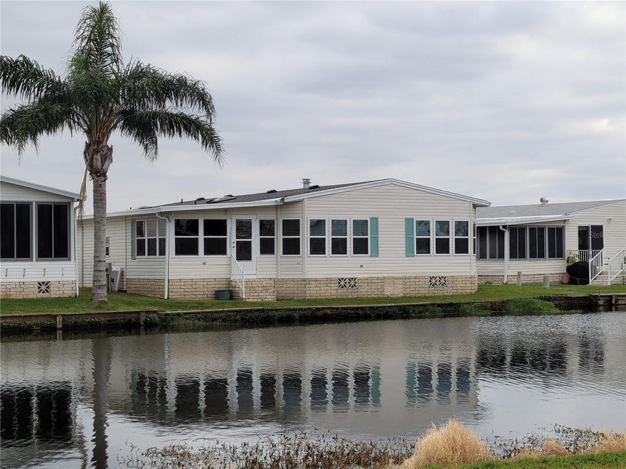 An amazing 1993 manufactured home on you own land! Water view as this home is on the pond. 1910 sq footage provides spacious rooms. There is a new Architectural Shingle roof that has "Cool Roof Technology" and a transferable warranty, New carport, New Windows, Insulated panels and door on Florida Room,  A formal DR / LR combo as you enter. The master suite takes the full width of the home! Deep closets, en-suite bathroom. The joy of this house is the 2020 updated Kitchen, with granite counter tops, breakfast bar, eating area, and the family room that enjoys the open concept with the kitchen. The view is delightful and available from all across the back of the house. There is a Florida Room off the kitchen (on AC system) that leads outside. Laminated Flooring, freshly painted, and totally updated! Unfurnished and no golf cart included. Enjoy 18 holes of golf for just $3 green fees in this Gated, Golf Community, located just outside of the city, and approx. 1.25 hr from either coast. Great access to Disney, Legoland, and BOK Tower, just to name a few local attractions. A Community where you enjoy $3.00 Green Fees as part of your HOA dues! In this very friendly, resident-owned community, you can be as active or inactive as you choose! Gatherings at the private Pub or the Community Room, fishing on Lake Henry, gardening, tennis, golf, shuffle board, pickelball, horseshoes, swimming in the heated pool, enjoy the hot tub or the workout room! Contact agent for this community's website address and documents, including Rules/Regs, Application, Financial, and Bylaws. HOA INCLUDES A DVR PLUS 2 HD CABLE BOXES AND INTERNET! (Minimum age in this 55+ community is 50 years old)