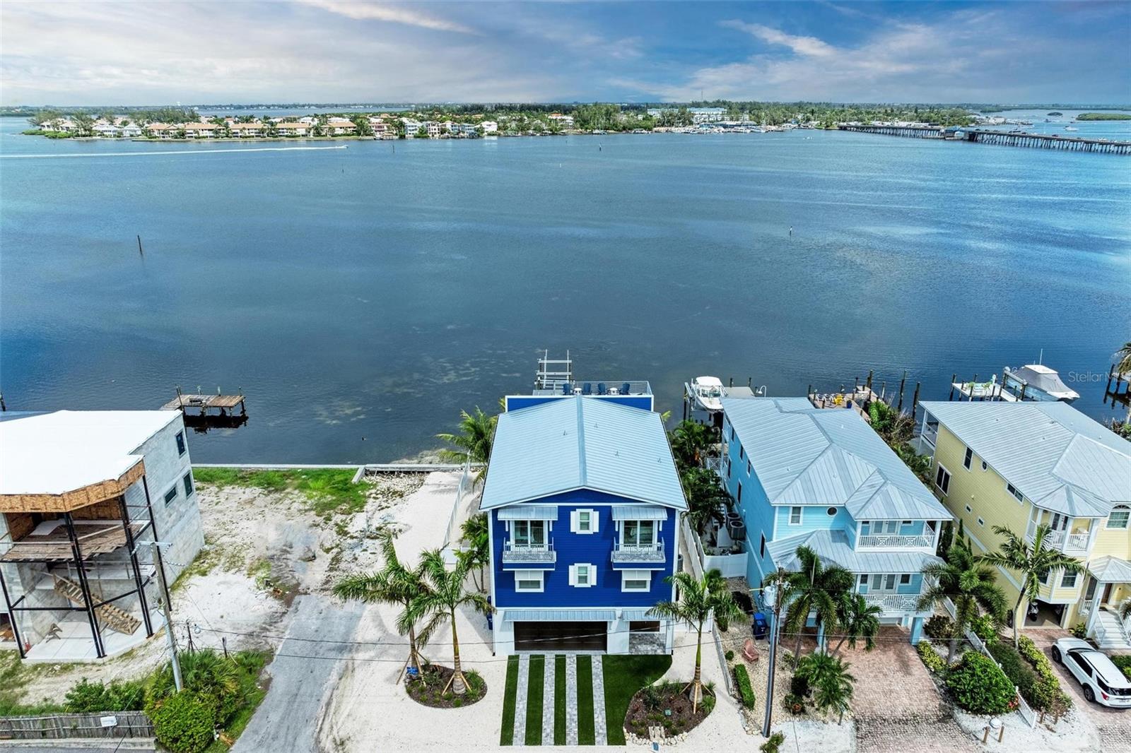 Welcome to Channelside! This new construction home sits directly on the Anna Maria Sound with your own private dock and 16,000-pound lift. This island retreat features 7 bedrooms and 8 bathrooms with a rooftop deck for 360-degree views of Anna Maria Island. The world-famous beaches of the Gulf of Mexico are only steps away giving you the best of worlds: a private dock for boating and easy access to the beach! Enjoy direct water views from your private heated pool and spa while having space for the whole family with all bedrooms having ensuite bathrooms. All furnishings were selected by a professional interior designer, and they are included in the purchase. Come see why Channelside would make the ideal island home or investment property. VIEW THE FLY THROUGH VIDEO and schedule your private showing today!