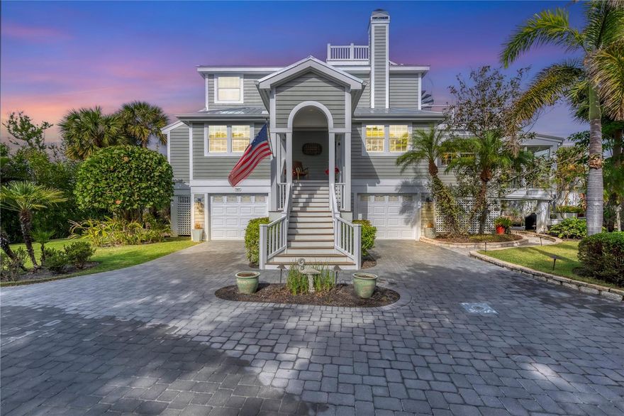 This unique bayfront home offers stunning sunrises and moonscapes over Charlotte Harbor. The spacious open main floor begins with an entry leading into the two-story living room with hand painted coffered ceiling. This space is accented by the hand painted staircase, custom tera cotta tile floors and a fireplace surrounded by a hand carved pecky cypress mantle. The adjoining dining room continues into the heart of the home providing quiet dining and harbor views. Step down into the kitchen and open family room. The kitchen is completely updated with stainless appliances, granite countertops and a spacious island with a second sink. Both rooms feature cherry flooring, custom woodwork and designer cabinetry with storage features. Adjacent to the kitchen and family room, a waterfront sunroom spans the width of the home, leading to a custom, window filled stairwell to the first-floor storerooms, doubled garage spaces and a garden patio. The property finishes with a garden view leading to the mangrove coastline. 

There are two large main level guest rooms, one en-suite and a second with an adjacent full bath. The upstairs primary suite welcomes you with built-in shelving and desk, vaulted ceiling and expansive windows facing Charlotte Harbor. The open Roman bath, large walk-in closet and laundry room complete the space. Open the large French doors in the primary bedroom to enter a private deck with amazing harbor views. To complete the deck, a circular staircase leads to a widow's walk with a panoramic view of Gasparilla Island and beyond. Additional highlights include a finished elevator to the first floor, impact glass on all windows and doors, a new metal roof installed in 2023 and all interior walls freshly painted. This North Bay gem, in the amenity rich Boca Bay community, is a true sanctuary combining location, style and natural beauty.
