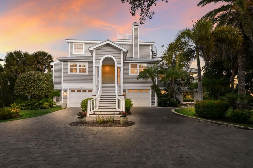This unique bayfront home offers stunning sunrises and moonscapes over Charlotte Harbor. The spacious open main floor begins with an entry leading into the two-story living room with hand painted coffered ceiling. This space is accented by the hand painted staircase, custom tera cotta tile floors and a fireplace surrounded by a hand carved pecky cypress mantle. The adjoining dining room continues into the heart of the home providing quiet dining and harbor views. Step down into the kitchen and open family room. The kitchen is completely updated with stainless appliances, granite countertops and a spacious island with a second sink. Both rooms feature cherry flooring, custom woodwork and designer cabinetry with storage features. Adjacent to the kitchen and family room, a waterfront sunroom spans the width of the home, leading to a custom, window filled stairwell to the first-floor storerooms, doubled garage spaces and a garden patio. The property finishes with a garden view leading to the mangrove coastline. 

There are two large main level guest rooms, one en-suite and a second with an adjacent full bath. The upstairs primary suite welcomes you with built-in shelving and desk, vaulted ceiling and expansive windows facing Charlotte Harbor. The open Roman bath, large walk-in closet and laundry room complete the space. Open the large French doors in the primary bedroom to enter a private deck with amazing harbor views. To complete the deck, a circular staircase leads to a widow's walk with a panoramic view of Gasparilla Island and beyond. Additional highlights include a finished elevator to the first floor, impact glass on all windows and doors, a new metal roof installed in 2023 and all interior walls freshly painted. This North Bay gem, in the amenity rich Boca Bay community, is a true sanctuary combining location, style and natural beauty.