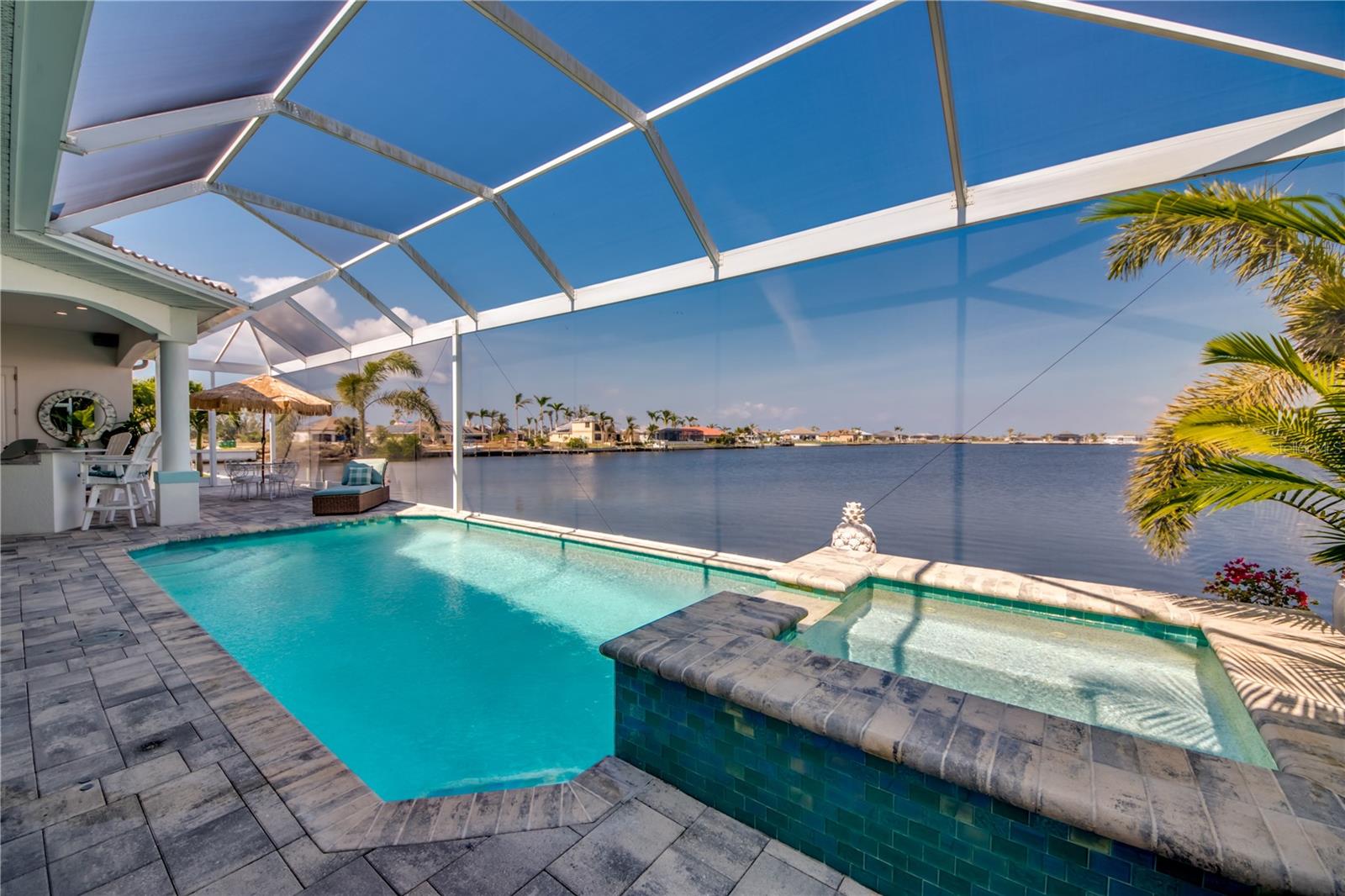 Gulf Access, Luxury Home- Enjoy Amazing Lake Views throughout! This is not your cookie cutter new construction home. The sellers paid attention to detail. Move-In Ready 3BR/3BA/3 CAR oversized Garage. This Beautiful home has been meticulously maintained. Enjoy the Large Outdoor Kitchen, Pool bath, Saltwater Heated Pool, Spa and Picture window screening. The Spacious Living room has Gorgeous Back-lit LED tray ceilings as well as the Owners Suite!! Kitchen- Sealed Horned Granite, SS appliances, Double Oven, New Monogram cook top & range and bar. Crown molding throughout, updated fixtures, plantation shutters, Impact Windows and doors. The Master suite has sliding doors leading to the spa, and walk-in closets. Master bath has a large soak tub and oversized stone shower with two shower heads. Split floor plan, & tile floors throughout! Outside features stylish paved driveway, rock beds, mature landscape & Newer Tile roof! Relax poolside knowing this home checks all the boxes. Boaters dream, Perfect blank slate for your custom dock! Short boat ride to Matlacha/ pine Island. No bridges along the way just amazing views! Seawall 2018 /See 3D tour and schedule your appointment today!