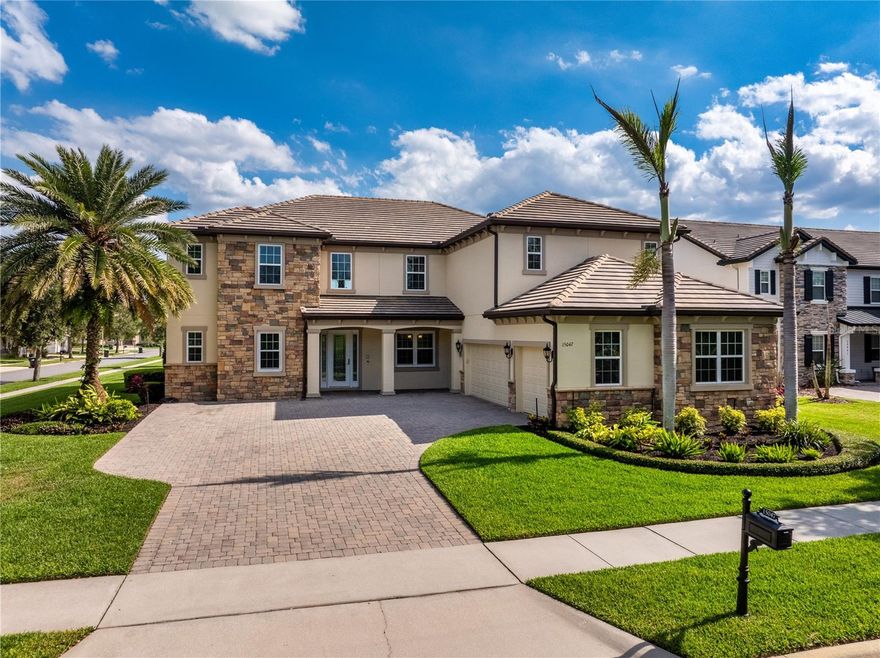 This is the one you’ve been waiting for! Tucked away on a peaceful cul-de-sac and situated on an expansive half-acre corner lot, this stunning Horizon West home, in the highly sought-after community of Independence, offers exceptional curb appeal, privacy and luxury living at every turn. Inside, experience soaring, double-height ceilings and an abundance of natural light that fills the spacious, open-concept living area. The thoughtfully designed floor plan features a private office, a formal dining room and an oversized main living space with incredible two-story ceilings and breathtaking views of the resort-style pool and outdoor entertaining areas. At the heart of the home is the chef’s kitchen, complete with extensive cabinetry and storage, a large center island and top-of-the-line stainless steel appliances, perfectly designed for both everyday living and entertaining. The spacious owner’s suite is a true retreat, featuring custom walk-in closets and a spa-inspired bath designed for relaxation. An additional main-level living space offers incredible flexibility and can easily serve as a private guest retreat or multigenerational living suite. Upstairs, entertainment takes center stage with a spacious bonus and playroom, an included pool table and an impressive, dedicated private home theater, featuring luxury powered seating for eight with a built-in projector and amazing quality in-wall surround sound for the ultimate movie-night experience. Outside, enjoy your private backyard oasis. The inviting and refreshing oversized pool showcases a stone wall spillover water feature and Baja sun shelf, all surrounded by lush landscaping for added privacy. The expansive lanai offers two separate seating areas, plus a natural gas fire pit and outdoor kitchen, creating the perfect setting for family fun and entertaining. Beyond the pool area, you’ll find more than 2,000 square feet of private, fenced backyard space with lush grass, shaded by mature trees, ideal for play, pets or relaxing outdoors. Additional upgrades include an oversized, three-car garage plus workspace, a dependable, powerful 20-kilowatt-hour Kohler whole-house generator, two tankless water heaters, a newly-upgraded HVAC and pool equipment and newer pool solar panels, all offering added efficiency and peace of mind. In a community known for its beautiful lake views, incredible scenery and abundant natural wildlife, this home also offers nightly views of Disney fireworks, spectacular sunsets over Lake Hancock and unforgettable rocket launches, all from inside and around this beautiful home. Experience this incredible home in the ideal location for yourself, and discover luxury living at its finest.