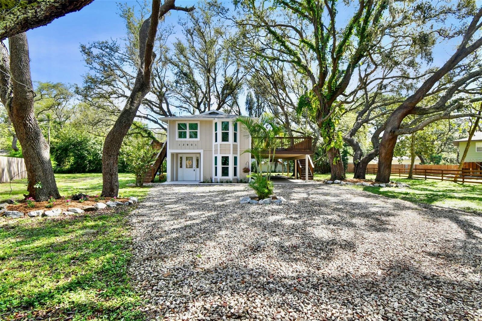 One or more photo(s) has been virtually staged. Welcome to this charming 3-bedroom, 2-bathroom home offering 1,700 square feet of living space in the desirable community of HOLIDAY CLUB in Odessa! Nestled along a breathtaking chain of lakes, including the 100-ACRE SKIABLE LAKE ANN, with a private BOAT RAMP! This home has been FULLY REMODELED and no detail left untouched and sitting on a .37 acre OVERSIZED LOT! Plenty of room to build a detached garage or ADU! Step inside to discover a fresh and modern interior, featuring new flooring throughout, all-new kitchen and bathroom cabinets, sleek countertops, and stylish finishes. A BRAND-NEW ROOF, AC, IMPACT WINDOWS, kitchen cabinets with a STAINLESS STEEL APPLIANCE SUITE, QUARTZ COUNTERTOPS and updated plumbing to ensure peace of mind and worry-free living. The home’s layout offers convenience and flexibility, with the master bedroom with en suite bathroom located on the second floor and two additional bedrooms on the first level. FRESHLY PAINTED inside and out, the property also showcases NEW stairs and railing, plus a spacious NEW deck on the west side for enjoying the outdoors. Located in FLOOD ZONE X with a LOW HOA that includes access to fantastic amenities such as… a SECURE FRONT GATE, community playground with basketball court, a PRIVATE BEACH/PARK with boat ramp and volleyball court, 2 docks, picnic areas with grills, and all within a GOLF CART FRIENDLY community. This home offers the ideal blend of comfort and active lakeside living. Park all your toys in the oversized lot (.37 acre), with plenty of room for your RV, boat or trailer! Zoned for incredible local schools, and centrally located just 12 minutes to the Veterans Expressway, and 30 minutes to Tampa International Airport. Don’t miss your chance to own a move-in ready gem in one of Odessa’s most sought-after lakefront neighborhoods!