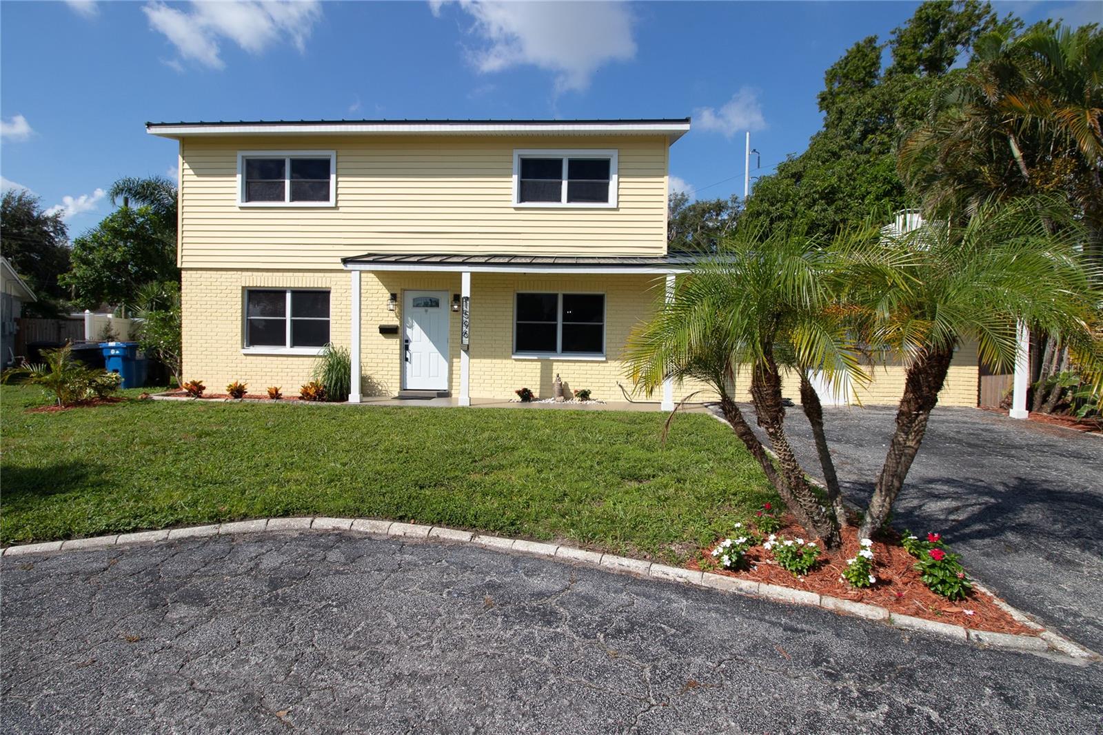 This beautifully updated home is ready for a new occupant. Move right in and start enjoying the space and the yard. The property is oversized at more than a quarter acre. The sparkling pool outside and covered patio have relaxing vibes as well as fun pool day vibes with family and friends. There is a bonus half bath in the little pool house that is not included in the total bathroom count. This makes it convenient for everyone without having to have people running through the house! Pulling up to this cheerful and welcoming home, you will be right at ease. Walking in, porcelain tile stretches through the comfortable living room to your left, and the beautiful kitchen and dining area to your right. The living room will accommodate large furniture or multiple seating areas. In the recently remodeled kitchen you will find generous Pompeii Quartz countertops, perfect for all of your prepping, cooking, baking, or entertaining needs. The double oven and six burner gas stove make cooking a breeze, no matter how many people you are serving. Plenty of cabinet and drawer space will neatly store all of your pantry provisions and kitchen gadgets. Off of the dining room is a huge bonus room. This could meet many needs, from a family room, playroom, home gym, etc. There is an inside laundry attached after the walk in pantry and storage area. Off of this room is another large room, opening to the patio. This would be a great bedroom or entertaining space. The hallway between the kitchen and living room also leads to the downstairs half bath and another room that would function as a bedroom or perhaps an office. Upstairs are three well sized bedrooms with original wood floors. Both bathrooms were just remodeled with a beautiful and serene porcelain tile in the showers and lovely fixtures. The hall bath has a tub, and the primary ensuite bath has ample storage and a walk in closet adjacent. The metal roof was replaced in 2022, and a brand new HVAC is going in as well. Located near Publix and Target, as well as easy access to I275. This home does not require flood insurance and has never taken on water.