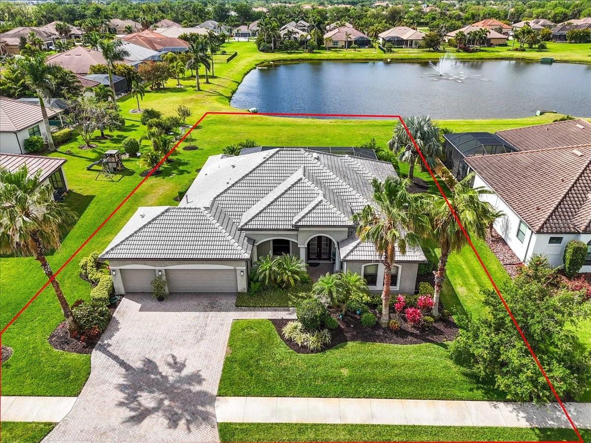 Welcome to luxury living at its finest in the prestigious, gated Enclave at Country Meadows—an intimate community of just 68 executive homes. This expanded Aruba model by Medallion Homes was designed to be wider in the living, dining and kitchen areas as well as the primary bedroom and walk in closets. This stunning home offers over 2,600 square feet of elegantly designed living space on nearly half an acre, featuring breathtaking pond views and a captivating color-changing fountain.
Step inside to discover 3 bedrooms, 3 full baths, plus a spacious den, all designed with impeccable craftsmanship. The gourmet kitchen is a chef’s dream, featuring New Cambria quartz countertops, a built-in microwave, convection oven, warming drawer, and a 36" gas cooktop powered by a 250 gallon buried propane tank—also serving the water heater, dryer and outdoor kitchen.
The primary suite is a private retreat, offering direct access to the enclosed, resort-style saltwater pool, equipped with new salt generator and newer pool pump. Enjoy a spa-like ensuite with a soaking tub, dual sinks, an expansive walk-in shower, and two custom walk-in closets. The open living area boasts a seamless indoor-outdoor flow with a wall of sliding glass doors that fully retract. The split floor plan is perfect for entertaining out of town company and the pool bath allows for easy access in and out of the lanai!
Step outside to your outdoor oasis, where the full summer kitchen includes a built-in grill, gas stove top, wash sink with garbage disposal, and refrigerator—perfect for entertaining while taking in serene pond views. Best of all, the south-facing backyard ensures you can enjoy the pool all day long, while taking in the spectacular sunsets each evening.
Rest easy knowing this home features hurricane shutters, a whole-house propane-powered generator, and a desirable X flood zone location—no flood insurance required. It also has an irrigation system supplied by it's own well and 2 new AC systems! This home is loaded with extras!
The stunning outdoor spaces, high-end finishes, tray ceilings, crown molding and thoughtful details throughout, make this an ideal retreat. Don’t miss this rare opportunity to own a slice of paradise in the Enclave at Country Meadows!