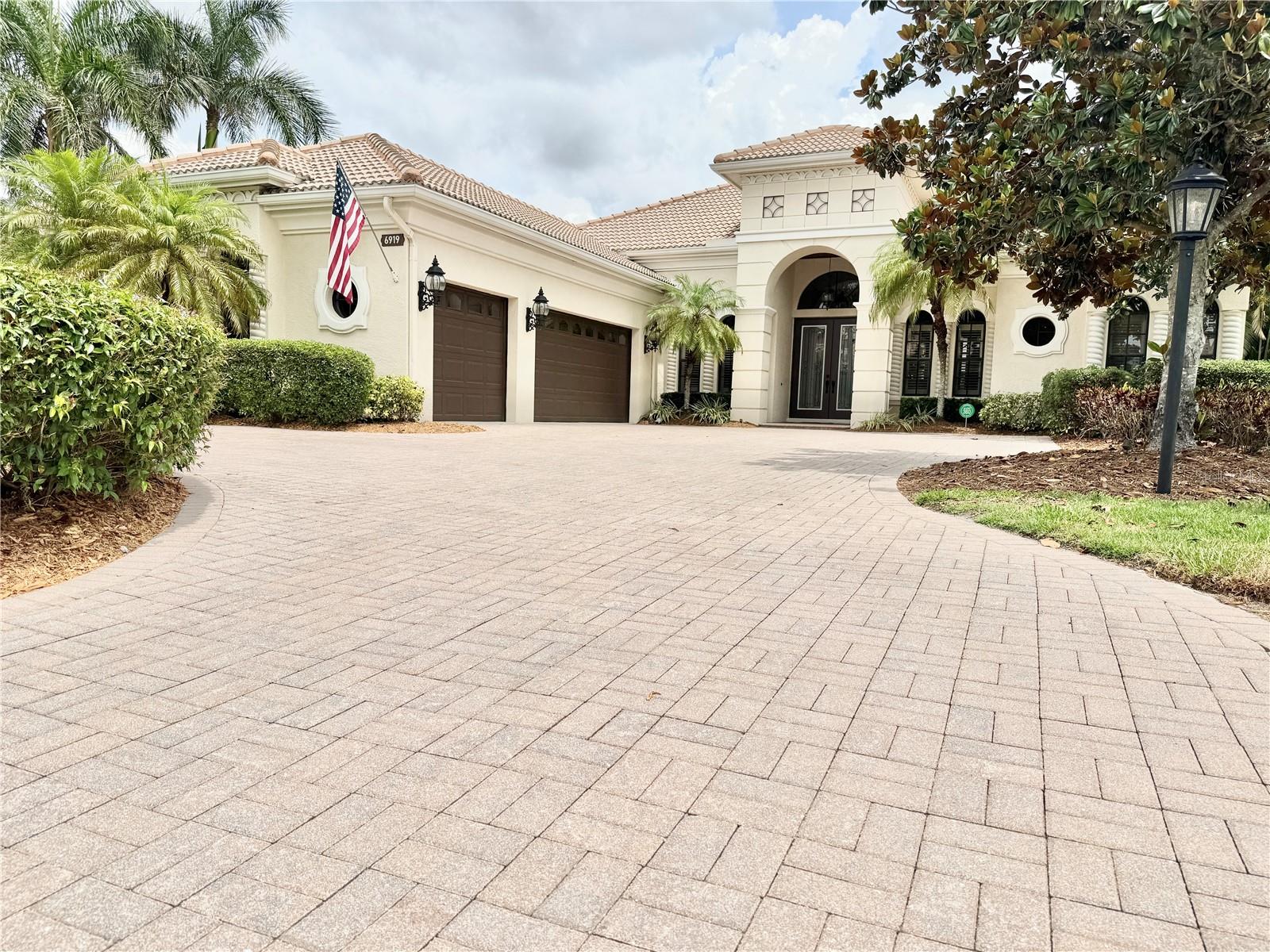 Welcome to "The Dominion" of Lakewood Ranch Country Club.
The Dominion is one of the most exclusive and desirable neighborhoods behind the gates of Lakewood Ranch Country Club. This custom Arthur Rutenberg masterpiece – The St. Vincent II model – offers the best in Florida luxury living. Perfectly situated on a premier homesite with breathtaking views of the golf course and glistening lakes, this "like new" 5 bedroom, 4 full bath, 2 office, is move in ready and even has a spacious upstairs bonus room, private guest suite, and covered balcony that overlooks the golf course and pool. This home provides the ideal blend of space, elegance, and function. The thoughtfully designed floor plan includes a newly updated chef’s kitchen with solid Wood Cabinetry & built-in pantry, Quartz counters, high-end appliances, and an open layout with beautiful outdoor views that flow through the Gathering Room—allowing for perfect entertaining and everyday living.
Architectural details abound: the stately exterior beckons you inside to take in the intricate crown molding, high tray ceilings and built-in features. The executive office located in the front of the home is spacious with built-in work space, cabinetry and is full of natural light. The secondary office/flex room (with full closet) is located at the rear of the home overlooking the golf course, and sliding glass doors open onto the pool deck. High decorative ceilings throughout create a sense of timeless sophistication. The primary suite is conveniently located on the main floor in its own private wing. With high ceilings, access to the pool and lanai area, this suite will accommodate large estate furnishing in style. Dual walk-in closets, and a luxurious and recently updated bath with a large walk-in shower, garden tub, and private water closet with bidet, round out the primary suite.
Step outside to your private saltwater pool and spa oasis, surrounded by lovely paving brick, and unwind under the covered lanai or in the cabana with a fully equipped modern summer kitchen—perfectly designed for year-round entertaining. The circular drive, side-entry garage, and dual 220V EV charging stations add modern convenience as well as curb appeal.
RECENT UPDATES: travertine-style porcelain tile, luxury vinyl plank flooring, new countertops throughout (except office), newer appliances including dishwasher, refrigerator, oven, cooktop, and dual-function microwave, front loading washer and dryer, All 3 AC units replaced with high-efficiency filter systems, and a 24KW natural gas Generac Whole House Generator will keep everything running during power outages, updated security system, recently refinished wood ceilings and freshly painted cabinetry (excluding office), along with an upgraded outdoor grill and hood.
Enjoy resort-style living with an optional membership to The Lakewood Ranch Country Club—offering 4 championship golf courses, 3 luxurious clubhouses, 18 Har-Tru tennis courts, pickleball, state-of-the-art fitness and aquatic centers, walking trails, and many social events. With no waitlist and optional membership, the choice is yours.
Situated near high-rated schools, premier medical facilities, parks, shopping, dining, and just minutes to Gulf Coast beaches, this property represents not just a house but a lifestyle of luxury.
Live the dream—schedule your private showing today!
**THIS PROPERTY QUALIFIES FOR A 1% LENDER INCENTIVE IF USING PREFERRED LENDER. INQUIRE FOR MORE DETAILS.**