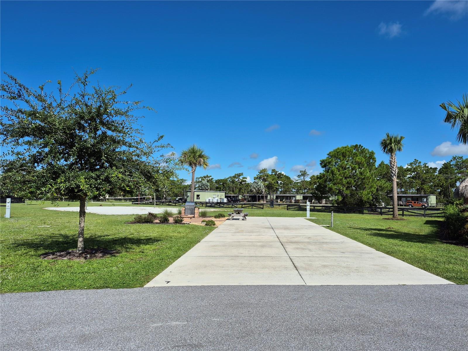 Welcome to the Resort at Canopy Oaks in Lake Wales, Florida! Surrounded by the beauty of natural Florida, this premier RV destination offers resort style amenities including a large pool and hot tub, a 12,000 sq. ft. clubhouse, full-service tiki bar, on-site café and general store, pickleball courts, shuffleboard, bocce, fishing ponds, dog parks, and picturesque walking trails. This deeded premium site provides a peaceful, private setting with plenty of space to relax, a beautiful brick paver fire pit, and close proximity to the clubhouse and activities. The generous 20’ x 70’ concrete pad features full hookups (20/30/50 amp) and easily accommodates Class A, Class C, fifth wheels, travel trailers, or even a small park model—making it the perfect carefree seasonal retreat.