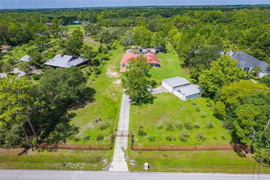 INVESTOR SPECIAL !!! NEEDS REPAIRS. Amazing opportunity to Fulfill Your Country Life Dreams** East Orlando Pool Home with 2 acres of land where you have space for your RV, Jet Ski, or Trailer? Or maybe have some pets/animals? There's a gazeebo in the back just for you. This property has the choice of closing one door and will have 3 units under one roof. A 3/2 with living, dining and kitchen on the right side of the home, a 2/1 with living, dining and kitchen and a Studio with Bathroom and Kitchen on the left side of the home. **2 Acres and Huge in ground Pool** with a Great Location.**Only 5 miles from Waterford Lakes and UCF. This home has lots of possibilities to make this property your dream home with some repairs and TLC. The car Garage has been converted to an apartment (also needs some repairs). Has 2 standing garages on premises. NO CDD and NO HOA.