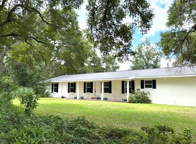 One or more photo(s) has been virtually staged. First time on market! Charming 10 Acre property in highly desired area of Hibiscus Park only 7 miles to The World Equestrian Center. This property has so many options / opportunities. It is completely renovated 4/2 with all new kitchen stainless steel appliances, granite counters, bathrooms with new cabinets, tile shower owners, new lighting / fans, paint, mechanicals, hot water heater, washer & dryer, garage door opener and new roof. Primary bedroom has hardwood floors and the remaining have brand new fresh carpet. Adorable reclaimed wood from original homestead barn/workshop out the back screened porch that serves as excellent storage and a lean to shed in back field. Plenty of spots to add a barn and / or arena if desired. We already have barn plans and resources that we can provide for this. Blackboard Fenced and cross fenced with Beautiful Iron Gates that greet you on your drive in between the Giant Oak Trees. USDA 0 percent down eligible! All the peace & quiet you can find with no HOA and immediate access to local amenities with superior location.