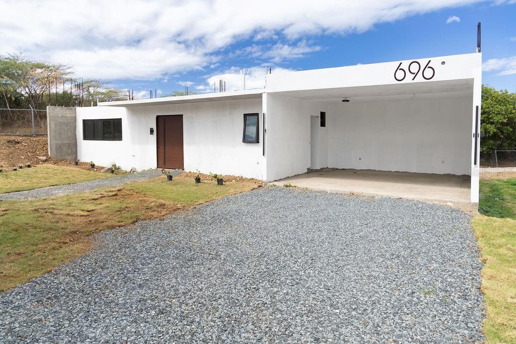 This modern beach front home is a brand new luxury construction in an unmatchable location! Located on the quiet Bastimento beach and just steps from the ocean’s relaxing waves, the North shore’s sunrises, sunsets, and Tradewinds are the backdrop to this beach lovers dream. Solidly built with clean lines and massive spaces, the sleek and elegant architecture makes this structure the perfect canvas to finish with your own personal touches.
The vast kitchen space, lofty dining and living areas and elevated ceilings evoke the classic minimal design of a Malibu beach house. The open concept, and towering windows create an illuminated and airy home for unequaled ocean front living. The home has a spacious bathroom and 2 king-sized bedrooms, with the principal bedroom oriented to face the beach. At the heart of the house, is the ideal space for a central pool and courtyard. The interior roof access was thoughtfully placed to create a second story or a rooftop garden.
With a generous yard and preliminary landscaping, the property’s private garden with become a stunning and blooming personal paradise. The property is fully fenced in with a motorized gate access and a double covered carport. A second gate in the rear conveniently provides ocean access making the peaceful tide pool just beyond feel like an extension of your back yard.
This property will become the ultimate family beach house or an extraordinary rental opportunity.
