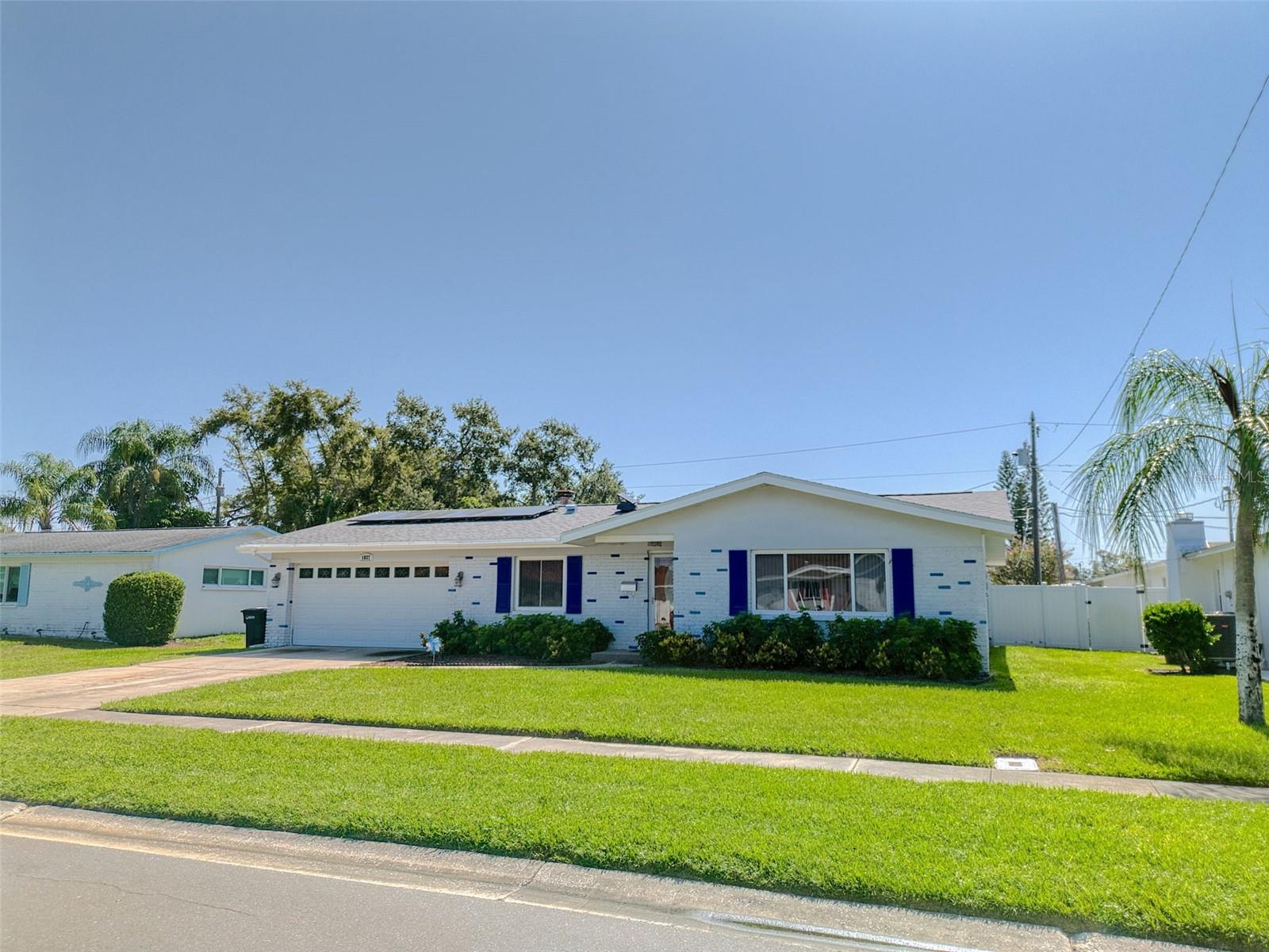 This is a lovely well cared for home with a screened in pool, newly resurfaced, and a two car garage. Solar power for reduced energy bill.
A four bedroom split plan style home with washer and dryer in garage. Pool and lawn care included with annual rental. The primary bedroom features a jack and jill bath with shower. The hall bath has a tub. The kitchen is handy for creating meals, with a view of the pool and it features a dishwasher and garbage disposal. Situated amongst other similiar homes in a neighborhood with access to north and south bound US 19. Upon entering there is a formal dining room or den or make it an office to the left and a formal living room to the right. Continue through the kitchen and the open living area with a beautiful fireplace and through the sliding glass door to the pool. This home is currently partially furnished as shown and is available for short term not less than a month as well as annually. May be unfurnished too. PET friendly. Amenities and price vary according to length of stay and season.