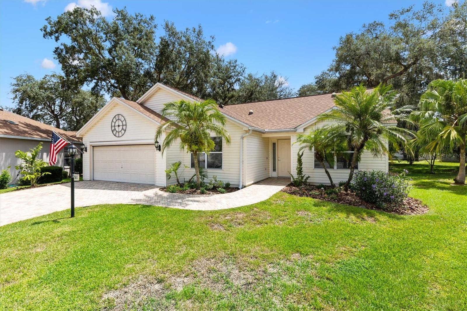 NO BOND! ROOF AND HWH 2015. 2-bedroom, 2-bathroom with Den on 1/4 acre LESS THAN 2 MILES TO SUMTER LANDING AND SPANISH SPRINGS. Nestled on a serene cul-de-sac in the Village of De La Vista West. This home offers exceptional curb appeal with a paver driveway, paver patio, and a charming covered entry. Inside, the thoughtfully designed split floor plan provides both privacy and function. The eat-in kitchen features all-new stainless steel appliances, granite countertops, and a convenient pass-thru to the open living and dining room. The living room and primary bedroom are huge with a nine-foot expansion in length to both rooms! Adjacent to the Living room, the 3rd bedroom has been opened to create a sitting room that could also be used as a TV room, office or den. The large master suite includes a private sitting area, two oversized walk-in closets, and an ensuite bath with dual vanities, a glassed-in shower, and a window for natural light. The guest bedroom has an adjacent bath with tub shower combo. Step outside through sliding glass doors to experience the ultimate outdoor living space with a huge paver patio and a fenced garden enclosure, perfect for gatherings or quiet relaxation. The large backyard offers endless possibilities for gardening, adding a pool, or simply enjoying the outdoors. Additional highlights include: full 2-car garage with built-in cabinets, electric garage screen, Attic stair kit, Ring doorbell, Whole-house water filtration system, Three solar tubes in the kitchen, living room and guest bath. Village of De La Vista-West is 1.7 miles north of Lake Sumter Landing and 1.6 miles south of Spanish Springs. There is plenty of golf with the 18-Tierra Del Sol and 27-hole Hacienda Hills Championship Courses just over 1.3 & 4.3 miles respectively. De La Vista Executive Golf Course is just over a mile. Rio Grande Family Pool and the Tierra Del Sol Adult Pool just minutes away. You can treat yourself to dinner at Tierra Del Sol Restaurant and a show at The Villages Blackbox Theater. This location can’t be beat! Call today to schedule your private showing and start living The Villages dream.