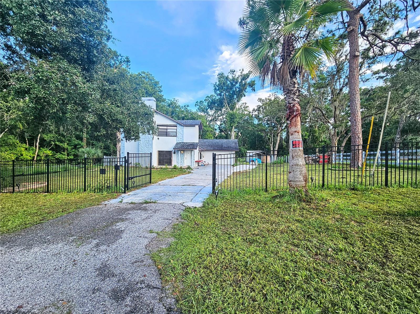 WOW! Welcome to the property where you can have a country atmosphere close to the city conveniences! A rare find, 3 bedroom, 2.5 bath, 2 car garage home with swimming pool on over 3 acres in New Port Richey! Zoned Agricultural - bring your horses, chickens, pets!You will love the Private setting with no rear neighbors! Adjusted lot basically a Horse amenities that include new 3-rail wood fence with layered wire horse fence, 2-horse stable, hay and stack and storage, separation pen, and just a few miles East on 52 to POPULAR STARKEY WILDERNESS PRESERVE HORSE TRAILS - SERENOVA TRACT at 14900 SR 52! No HOA, No CDD, and plenty of space for all the toys!! Bring your 4 wheeler, RV, bike, truck, you name it!Thoroughly Remodeled. New, new, new! – New Kitchen, new bathrooms, new flooring! The Roof is 2021, the A/C 2017.Totally new electrical from the outlets to the electrical box, updated plumbing, Fairly new well & pump! Formal living room has a woodburning fireplace. The master bathroom have been renovated with new vanity and fixtures. Spacious Remodeled Kitchen with new wood cabinets and granite counters, new stainless steel appliances. Open concept with kitchen overlooking living room. Up the stairs to the second floor, there is so much more! Spacious loft with vaulted ceiling would be great as a family room or large office! Large 19x16 master bedroom with spacious walk-in closet and ensuite bathroom! Split bedroom plan with the master upstairs and two bedrooms downstairs! The pool overlooks your very spacious backyard that provides plenty of room for entertaining. Oversize 2- car garage with extra storage in the floored attic. You’ll enjoy the convenience of having the half bathroom off the garage. Outside you have shed, Long driveway, Property is Fully fenced! Close to US-52, Veterans Express Way.