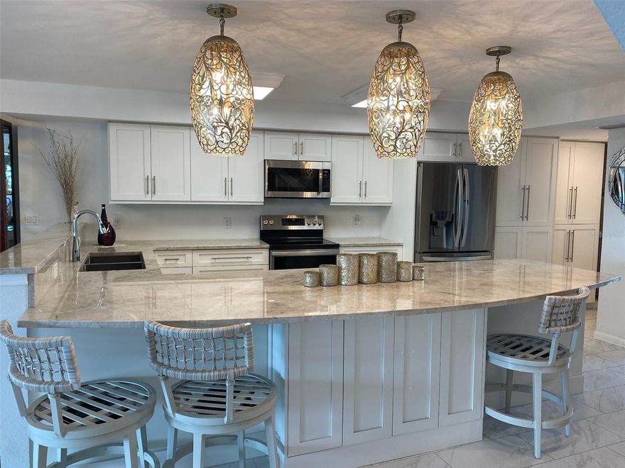 This elegantly updated condominium offers a bright, open layout that highlights natural light and peaceful water views. The spacious living and dining areas provide a comfortable setting for daily living, while sliding doors lead to a private balcony perfect for enjoying morning breezes and Florida’s signature sunsets. A beautiful ethanol-fueled fireplace adds style and warmth, with an additional storage closet discreetly located behind it. Live like you’re on vacation every day.

The home features an impressive open island kitchen with modern cabinetry, Quartzite countertops, upgraded appliances, a convenient pantry, and a streamlined layout ideal for cooking and entertaining. The island enhances workspace, storage, and seating, creating the perfect centerpiece for gatherings. Both primary suites offer peaceful retreats with three closets each, generous storage, and well-appointed bathrooms. Throughout the home, neutral tones and tasteful finishes create a timeless, move-in-ready environment. Additional upgrades include hurricane-rated doors, windows, and shutters for added peace of mind.

This residence is ideally located near some of the most desirable destinations on Florida’s Gulf Coast. Downtown Dunedin is just minutes away and offers boutique shops, waterfront parks, award-winning restaurants, breweries, art galleries, and year-round events. The famous Pinellas Trail is close by, providing miles of scenic paths for biking, walking, and outdoor recreation.

Nature lovers will appreciate quick access to Honeymoon Island and Caladesi Island—two of the country's top-rated beaches known for their pristine sands and turquoise waters. Clearwater and Clearwater Beach are approximately 10–12 minutes away, offering additional dining, entertainment, and world-famous shoreline. Travel is simple with St. Pete–Clearwater International Airport about 20 minutes away and Tampa International Airport roughly 30 minutes away.

Everyday conveniences such as shopping, grocery stores, medical facilities, golf courses, marinas, and fitness centers are all within a short drive, creating a complete and well-connected living experience. Community amenities include a pool, landscaped grounds, and well-maintained common areas, contributing to a peaceful and welcoming setting.

Whether seeking a full-time coastal residence or a seasonal retreat, this exceptional condominium combines comfort, convenience, and the unmistakable charm that makes Dunedin one of Florida’s most desirable places to live.