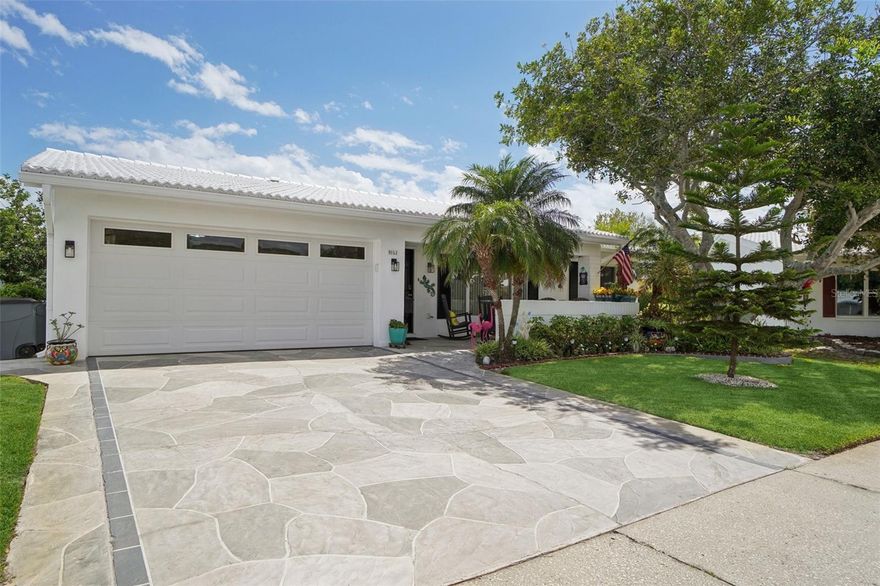 Forget everything you think you know about standard community living. From the moment you pull up to the lush, tropical landscaping, you’ll realize this is something special. Whether you’re enjoying a cold drink on the deep front porch, hosting a multi-course dinner, or just working from home, here you'll find details expected only in a much more expensive home but at a Mainlands price.  The kitchen has bar seating, a massive custom built pantry, double sinks, tons of cabinets and an island, all overlooking the beautiful landscaping. In addition there is a laundry closet - no trekking a hot garage to do the linens!  Need a home office or a quiet reading nook? The family room is separated from the den by custom barn doors, offering that privacy when you need it and open concept flow when you don't. This is a truly modern home, perfect for Florida living with a 2 car garage, concrete tile roof, double pane windows throughout, Electric panel 2024, HVAC 2018, hurricane rated garage door 2025.  The Mainlands is a vibrant, active and social community well serviced by a sparkling pool, public golf course, shuffleboard and a full calendar of scheduled events at the clubhouse.  It's located just minutes from the shops, movie theater and restaurants at Park Place, 2 major grocery stores and minutes from the US19 and I275.  Come and see this gem before it's gone!