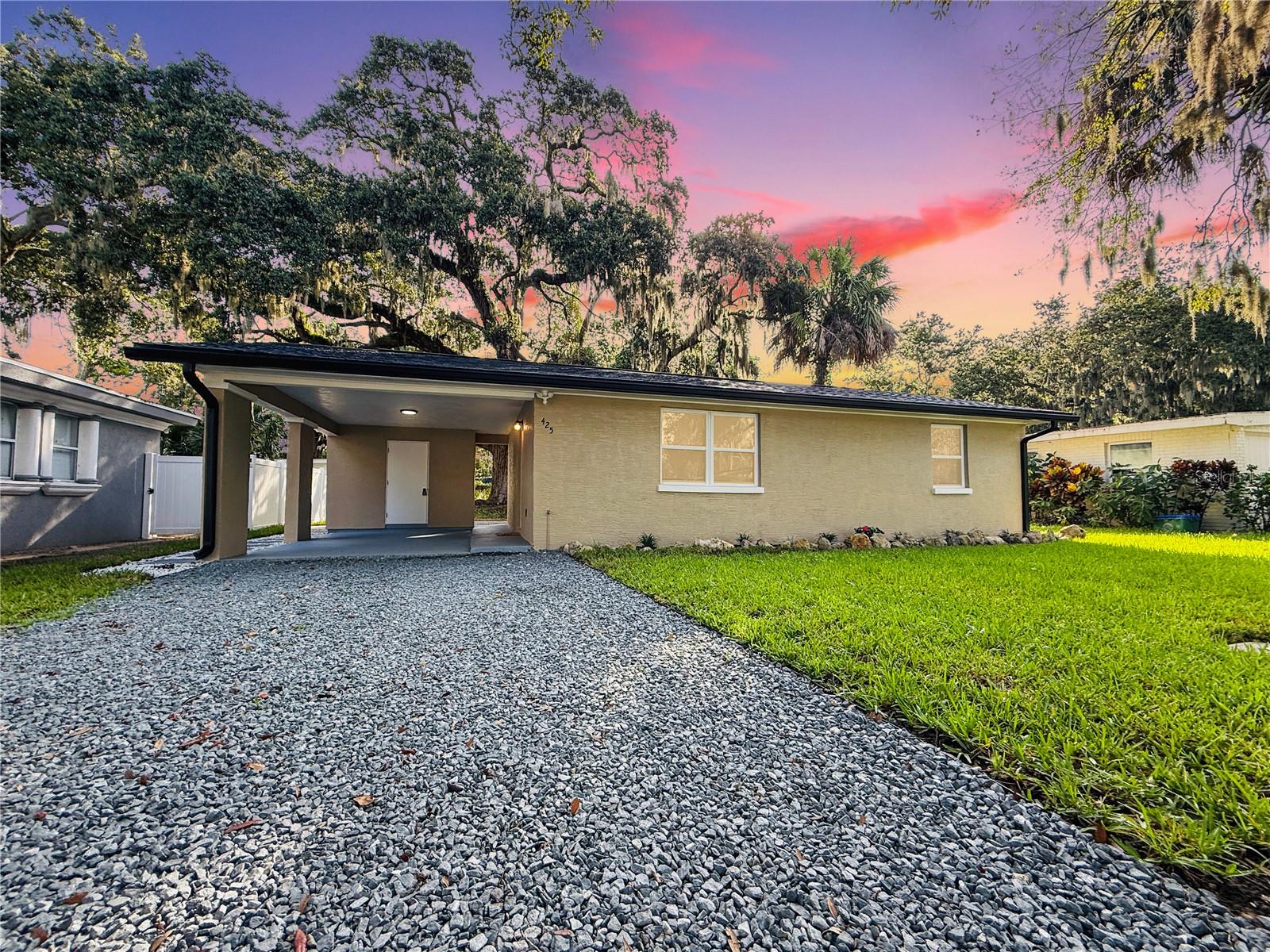 TOP-TO-BOTTOM TOTAL REMODEL - MOVE-IN READY! This beautifully updated 2 Bedroom, 1 Bathroom home with Carport has been completely transformed with NEW ROOF, NEW WATER HEATER, NEW HVAC, NEW WINDOWS, and NEW GUTTERS—all the big-ticket items are DONE! Inside, enjoy brand-new flooring throughout paired with stylish modern finishes. The kitchen boasts stunning granite countertops with matching backsplash and top-of-the-line LG ThinQ stainless steel appliances featuring green smart tech efficiency, making it both luxurious and eco-friendly. The remodeled bathroom feels like a spa, offering a glass-enclosed shower, Bluetooth speaker, and anti-fog color-changing mirror. Additional features include new fans with remote features, upgraded lighting, fresh interior & exterior paint, and new exterior security lights for safety and convenience. Outdoor living is enhanced with new pavers, a covered carport, and a spacious 60x105 lot, perfect for entertaining, gardening, or simply enjoying Florida Living. This property blends modern finishes, eco-conscious technology, and a full top-to-bottom remodel, making it the perfect turnkey home! Call for private tour.