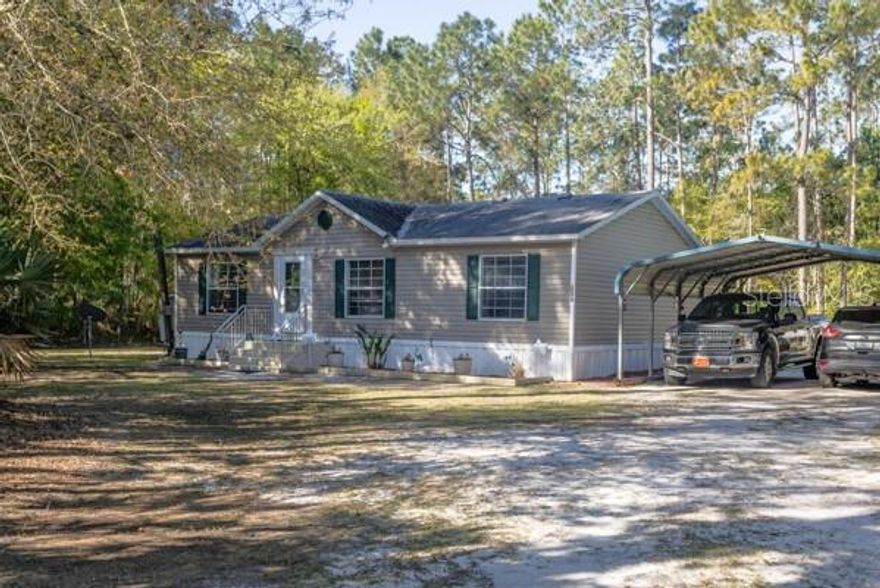 Dual Master Suites & Dream Workshop! This updated 2002 home offers the perfect setup for multi-generational living or guests. Boasting brand-new flooring, trim, and two fully renovated bathrooms, the interior feels fresh and modern. Major systems are updated with a newer A/C (3 yrs) and roof (8 yrs)  The real magic is outside:  28x40 Pole Barn with concrete slab.  Climate-controlled She Shed + Additional storage shed with electric.  Fenced & Gated for privacy and security.
Screened porch, covered patio, and raised planters for the green thumb. Fully accessible with a handicap ramp. This gem won't last—bring your hobbies and move right in!