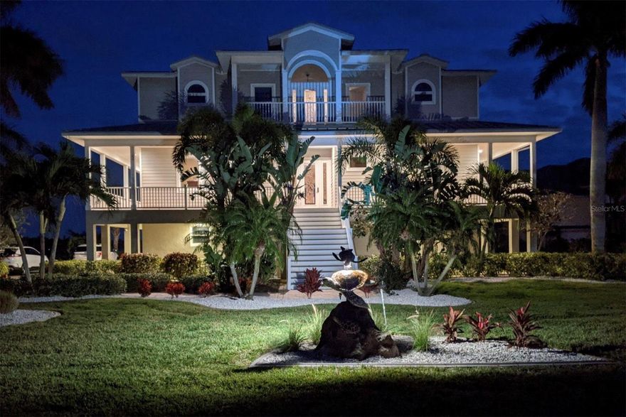 This exquisite Key West style home offers exclusivity, elegance and everything else you could hope for in a waterfront home. Nestled on over 1.25 ACRES OF LAND, this residence boasts PANORAMIC WATER VIEWS of Lemon Bay, direct access to the Intracoastal Waterway with NO-FIXED BRIDGES to the Gulf of Mexico, TWO SEPARATE BOAT DOCKS and DEEDED BEACH ACCESS. Gain peace of mind and security as this 2008 custom build with FIRST-CLASS CONSTRUCTION offers a concrete first floor with concrete poured pilings, Hardie board siding on the second and third floor, metal roof, impact glass windows and doors throughout, a WHOLE HOME PROPANE GENERATOR and elevated machinery. Along with a strong outside, the thoughtfully designed inside is filled with luxury and conveniences including a FULL ELEVATOR. The second floor, main living level homes the CHEF’S KITCHEN AND BUTLER’S PANTRY outfitted with a gas range, quartz countertops, Sub-Zero refrigerator/freezer, stainless steel appliances, double wall ovens, wine chiller, two dishwashers, ample custom wood cabinetry and a laundry with laundry chute! An electric fireplace is the center piece of the great room overlooking the whole home wrap around porch perfect for indoor/outdoor living and entertaining. Two bedrooms on this floor share a jack and Jill style bathroom with an additional half bath for guests. Upstairs, your MASTER SUITE RETREAT awaits complete with his and hers full bathrooms, a coffee bar with fridge, two large walk-in closets and access to the second private living room for quiet enjoyment. An expansive third floor deck provides the perfect place for your morning coffee, yoga routine or evening sunset reflection before bed. The fourth bedroom on this floor would make a perfect office, gym or guest retreat. Outside, your resort awaits with an ELEVATED OUTDOOR GAS KITCHEN and bar top sitting that overlooks the expansive yard and SALTWATER POOL WITH PROPANE FIRE PIT. Designed with a custom light package, sunshelf, lap pool and elevated spa that is all propane heated for quick enjoyment. Other notable features include the reclaimed hardwood floors and crown molding throughout, whole home dehumidifier, THREE CAR GARAGE PLUS THREE STALL STORAGE GARAGE, oversized paver driveway, exterior lighting, irrigation system with option for well and city water, downstairs full pool bath and extra utility room with hook ups for a second set of washer/dryer and refrigerator for pool towels and refreshments! PLUS MORE! The Pointe is a PRIVATE, GATED COMMUNITY of only 17 home sites where everyone has an assigned boat slip on the deep water canal with power and water. 5177 The Pointe has a DOUBLE JET SKI LIFT installed on their community slip while their private dock (which not every homesite has) features a 10,000# BOAT LIFT, fishing pier and ladder for kayak/paddleboarding. Every box is checked here and this rare location doesn’t come along often! Call today for your private viewing and a full list of features and improvements.