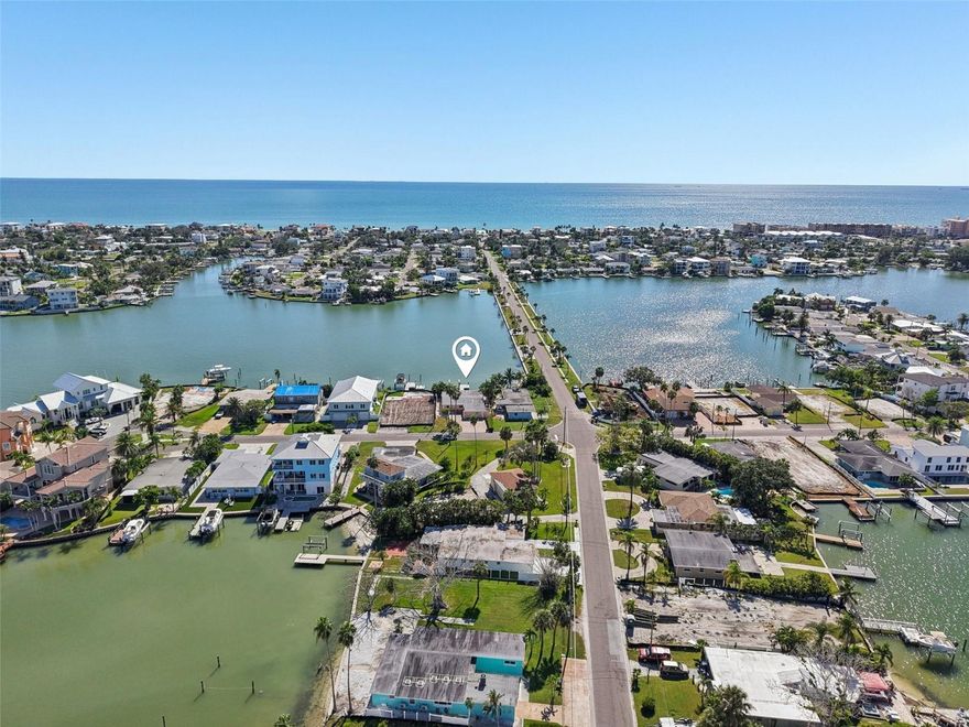One or more photo(s) has been virtually staged. **Seller Financing Options Available!** SELLER will remediate the home if you are renovating; prior to closing. This waterfront retreat in Redington Beach offers a rare mix of privacy, opportunity, and breathtaking views. The backyard is a true highlight, featuring a large paver patio that stretches from the back door to the dock—your feet never leave the paved surface. Lush plantings, including fruiting banana trees, create a private tropical oasis while you take in wide-open water views.

As a town resident, you’ll have exclusive access to Redington Beach’s private beach (with shower and maintained grounds) just a few blocks away on Gulf Blvd, along with parks and playgrounds reserved only for residents.

The property itself is remarkable. Deemed unsubstantially damaged, it features a solid concrete seawall, a brand-new dock, and a 13,000 lb boat lift with both water and electricity already in place. It’s ready to be rebuilt to its original glory and retains a coastal charm that can’t be replicated.

Inside, the home offers a spacious split floor plan with 4 bedrooms, 2.5 bathrooms, and a large living area designed around panoramic 360° water views. Expansive windows frame the turquoise waters and endless skies, making every room feel connected to the outdoors. A private mother-in-law suite with its own side entrance, half bath, and paver patio adds versatility for guests or extended family.

Life here is all about ease—dolphin-watching, boating, kayaking, biking to the beach, or simply connecting with friendly neighbors. While many in the area are tearing down to build new, this home offers a unique chance to keep a strong foundation and build back better, embracing the laid-back island lifestyle Redington Beach is known for.

This is more than just a home—it’s a rare opportunity to live in one of Pinellas County’s most private beach communities, where sunny mornings and spectacular sunsets are part of everyday life.

Opportunity awaits—schedule your showing today!