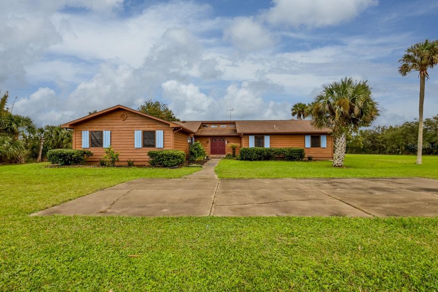 HUGE PRICE REDUCTION!! THIS Country Classic home is  located on 3.26 acres on the back waters of Turnbull Bay Creek. Enjoy fabulous fishing,crabbing and Boating and kayaking.. The home has Flagstone on the expansive front porch that continues into the Foyer. There are Vaulted ceilings, Large Living Room and Dining Room, an Extra Large Stone (Tennessee Creek Rock) Wood burning Fireplace that will heat the entire family room!There are 2 large Master Suites and  The large kitchen has a Country Charm Stove with a large breakfast nook that could be converted to an extra large kitchen and pantry, lots of possibilities! This home has 2 AC units for split cooling and 2 Hot Water Heaters so you never run out of Hot Water..The Walk in Closets in the master have laundry openings to put your laundry into the super laundry room. The garage is over sized and has many storage cabinets and room for plenty of tools...The yard has so many possibilities..Bigger Garage or workshop, Large burn pile for Bon Fires and of course the amazing view and use of the Water!! This home can be your Private Piece of Paradise!! ;Water: City