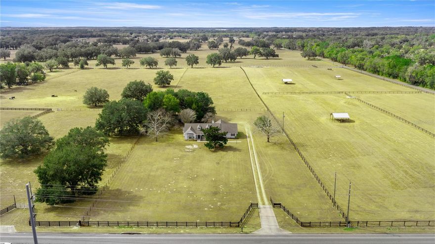 This well-maintained 1-owner home sits on 6.39 fully fenced acres with an electric gate, just minutes and 3 miles from WEC, I-75, shopping, hospitals, and all that Ocala has to offer.
Offering over 2,500 square feet of living space, the home features 4 bedrooms, 3 full bathrooms, including two primary suites, plus a bonus den ideal for a home office or flexible living space. The spacious living room is anchored by a wood-burning fireplace, creating a warm and inviting atmosphere for everyday living and gatherings.
Recent updates include a new stove and dishwasher, adding convenience and peace of mind. Step outside to the back porch and enjoy quiet evenings and beautiful Florida sunsets. With A-1 zoning, the property is horse-friendly and offers ample room to add a barn or additional improvements.
The seller is motivated, and the home is priced well below appraised value, presenting an exceptional opportunity to own acreage while still being close to Ocala’s premier amenities. This property offers the perfect blend of privacy, space, and convenience.