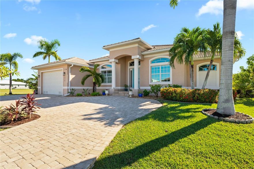Opulent Waterfront Luxury in Punta Gorda Isles — This 2015 D.M. Dean custom-built home offers 3 bedrooms, 3 bathrooms, plus office/den and a 2-car garage, perfectly situated on a private cul-de-sac street with circular driveway and direct access to Charlotte Harbor. With 59’ of waterfront and a 34’ concrete dock with a 10,000-lb boat lift, this home is a boater’s paradise and a haven for water enthusiasts. Inside, elegance meets function with soaring ceilings, oversized diagonal tile, and an open floor plan ideal for entertaining. The gourmet kitchen, remodeled in 2022, features Cambria quartz countertops, a farmhouse sink with wave-activated faucet, smart oven, and a chic bar with wine fridge and floating walnut shelves. The living and dining areas are enhanced by a 14’ custom tray ceiling, creating a refined yet inviting atmosphere. The master suite is a serene retreat with lanai access, custom tray ceiling, and a spa-inspired bathroom featuring dual sink vanity, oversized Roman shower with spa jets, jetted soaking tub, and private water closet. Guest bedrooms enjoy a split floor plan for privacy, while the third bedroom doubles as a state-of-the-art movie room with projector, Dolby 7.1 sound system, murphy bed, and ensuite bath. A versatile den/office with built-in bookshelves and custom barn doors offers endless possibilities—it can serve as a private home office, creative studio, library, formal study, or even a quiet retreat for reading or meditation, adapting seamlessly to your lifestyle needs. The fully equipped laundry room has quartz countertops and a second refrigerator adding further convenience. Step outside to your resort-style backyard: heated pool with waterfall, six-person spa, custom summer kitchen with double BBQ, sink, hood, TV, motorized storm screen, and a private outdoor shower—all surrounded by lush landscaping for ultimate privacy. This home embodies timeless elegance, high-end finishes, and the quintessential Florida waterfront lifestyle, perfect for entertaining, boating, or enjoying serene, luxurious everyday living.  Enjoy all the amenities that Punta Gorda has to offer such as biking, fishing, boating, dining, live entertainment, and much more! Close to Fisherman's Village, Ponce De Leon Park, Gilcrest Park, and Historic Downtown Punta Gorda.  Schedule your showing TODAY!