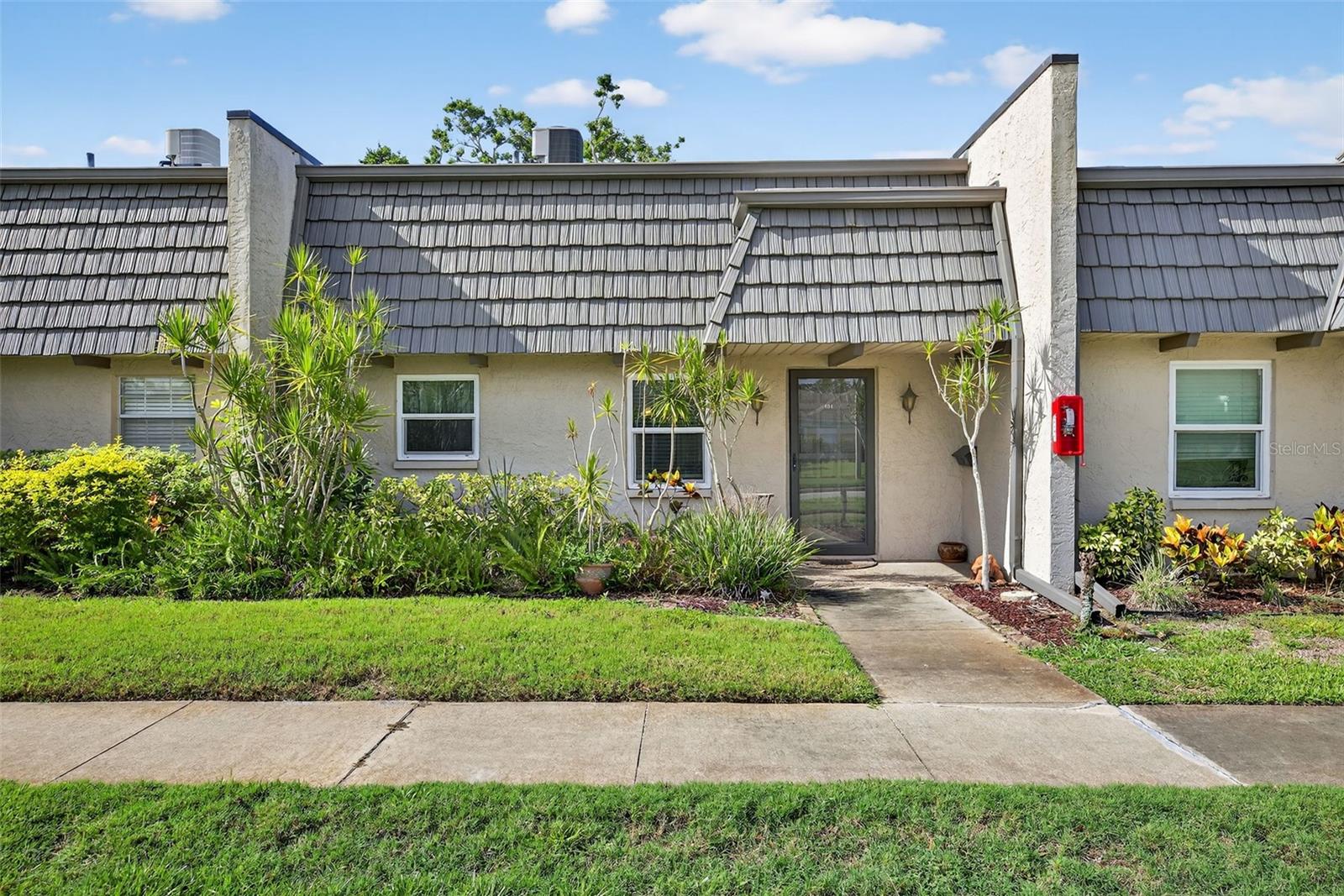Welcome to Cordova Greens, located in the desirable Bardmoor community! This charming villa-style condo offers the ease of one-story, first floor living, no stairs or elevators to contend with. An inviting open floor plan and carefree laminate flooring throughout. The updated kitchen features a breakfast bar with room for barstools—perfect for casual dining or entertaining. You'll also enjoy updated windows and sliding glass doors which also feature motorized rolling hurricane shutters for added protection, an updated bath, and the convenience of an inside laundry. The spacious master bedroom includes a walk-in closet, and the large private patio creates a relaxing, resort-like feel—ideal for morning coffee or evening unwinding. An additional feature is nice storage with a foyer closet and an attic, a rare find in a condo. There is approximately 80 additional square feet not included in the 784 square feet which would make a nice office space, exercise area or additional living area. An assigned carport, heated community pool and spa, and beautifully maintained grounds complete the package. Located in the heart of Bardmoor, you'll appreciate the golf course neighborhood, perfect for walking or biking, and easy access to shopping, dining, and major thoroughfares. This is Florida living at its finest! The Gulf Beaches are minutes away and this beautiful condo does not require flood insurance. Come view today before it is too late!