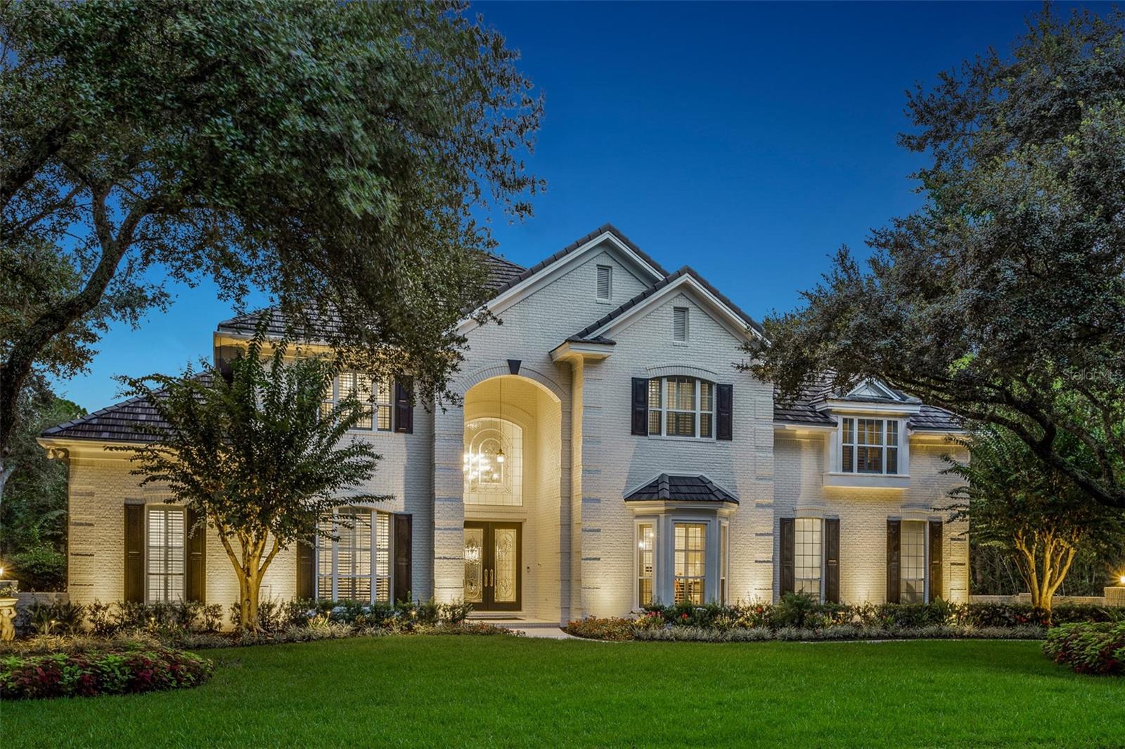 Sometimes the perfect home finds you twice—this one is now available for the next lucky owner. Purchased earlier this year, the sellers are only parting with it because they unexpectedly found their forever dream home. Their change of plans is your opportunity to own one of the finest estates in The Reserve at Tampa Palms, an exclusive gated community with 24-hour security.
This 6,590 SF estate sits on nearly half an acre with no front or rear neighbors, offering unmatched privacy and tranquil surroundings. The screened pool and spa overlook a peaceful pond and lush conservation area, creating a stunning backdrop where you can relax in complete privacy and enjoy nature every day. The home inspected exceptionally when purchased just months ago and remains in pristine, move-in-ready condition. A full inspection report can be shared with serious buyers to confirm how clean and well-maintained this property truly is.
The grand double-door entry opens to soaring 30-foot ceilings, a dazzling chandelier, and sleek 31” x 31” marble floors. A 350-bottle climate-controlled wine wall—both functional and a statement piece—divides the formal living and dining rooms. Expansive glass doors and an arched transom window flood the living room with natural light and frame sweeping views of the pool, spa, pond, and conservation beyond.
The chef’s kitchen is equipped with a Viking 8-burner gas range with double ovens, Sub-Zero refrigerator, Miele steamer, dual LG dishwashers, Viking chill drawers, and a farmhouse sink, all centered around a massive 9’ x 10’ granite island.
The downstairs primary suite offers a sitting area, gas fireplace, dual walk-in closets, and spa-like bath with jetted tub and walk-in shower. A private study with custom built-ins sits nearby. Upstairs are four additional bedrooms (three ensuite) and a media/game room.
Recent updates include:
• Tile roof (2019)
• 3.5 newer AC units (all within 5 years)
• 3 hot water heaters (2020)
• Whole-home water filtration (2021)
• Sonos sound system
The Reserve at Tampa Palms provides access to Compton Park’s exclusive amenities—Junior-Olympic pool, tennis & pickleball courts, playgrounds, and scenic walking trails—all within minutes of top-rated schools, shopping, hospitals, and Tampa Palms Golf & Country Club.
Rarely does a home of this caliber, in this condition, return to the market. Pre-inspected, impeccably maintained, and offering one of the most peaceful backyard settings in Tampa—don’t miss it.