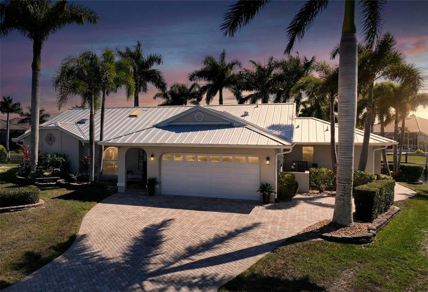 Welcome to the highly sought after community of Punta Gorda Isles!  This 3 bed 2 1/2 bath waterfront pool home features a stunning 182 feet of water frontage, breathtaking wide water views, and an outdoor lifestyle designed to impress. From the moment you enter, you’ll love the light-filled living room with vaulted ceilings and stunning canal views.  There are two spacious living areas plus a formal dining room with a custom dry bar, all perfect for entertaining.  The well appointed kitchen has stainless steel appliances, granite countertops, a built-in coffee system, and a pass-through window to the lanai - seamlessly connecting indoor and outdoor living. The primary suite has a large bedroom with a tray ceiling, private lanai access, an expansive walk in closet, and leads to your en suite bathroom. The bath features dual sinks, a walk in shower, and a separate soaking tub. A thoughtfully designed split floor plan includes a guest wing with pocket door for added privacy. Both guest bedrooms are large in size and there is a full bath with a walk in shower and convenient pool access. There is also a half bathroom. The interior laundry room has a laundry tub and added storage. Step on out to the pavered lanai and an extraordinary outdoor living experience plus an outdoor lounge patio. The heated saltwater pool showcases a water feature and variable speed pump, while the hot tub conveys with the home. The Viking outdoor kitchen elevates alfresco entertaining, all set against an expansive, panoramic water view with desirable southern exposure. Enjoy boating? You are only steps away from your THREE concrete docks & a 25,000lb boat lift with quick power boat access out to Charlotte Harbor and beyond to the open waters of the Gulf. With a jet ski lift, kayak rack, and fish cleaning station, you have a true waterfront playground right in your backyard. Other features include:  newer standing seam metal roof, gutters, impact skylights, impact windows, PEX piping, tile flooring throughout, plantation shutters, hurricane screens on the lanai, and an epoxy-finished garage floor with added shelving for optimal storage. This home is conveniently located to Fishermen's Village, downtown Punta Gorda, shopping, dining, medical, entertainment, and so much more.