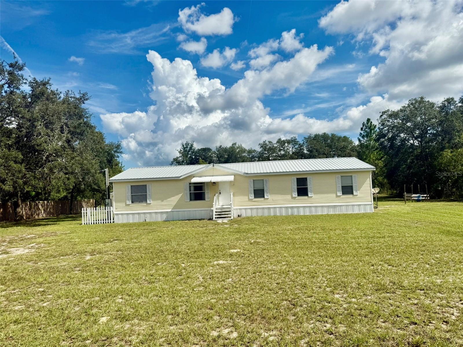 Charming 4-Bedroom Manufactured Home with Metal Roof in Westwood Acres South!
Welcome to this beautifully maintained 4-bedroom, 2-bathroom manufactured home nestled in the desirable Westwood Acres South community. Featuring a durable metal roof installed in 2017, this home offers both comfort and peace of mind. Inside, you'll find a spacious family room with a cozy fireplace, perfect for relaxing evenings, and a separate living room that provides additional space for entertaining. The well-appointed kitchen offers ample cabinetry and counter space, making meal preparation simple and enjoyable. The master suite boasts a Roman tub, separate shower, dual sinks, and a walk-in closet. Vinyl flooring flows seamlessly throughout the home, complementing a functional layout with generously sized bedrooms and two full bathrooms, ideal for family or guests. Set on a private lot, this property offers a peaceful setting while still being conveniently close to shopping, dining, and major highways. Plus, it’s just 10 minutes from Rainbow Springs and 15 minutes from the World Equestrian Center.
Don’t miss this incredible opportunity—schedule your showing today!
