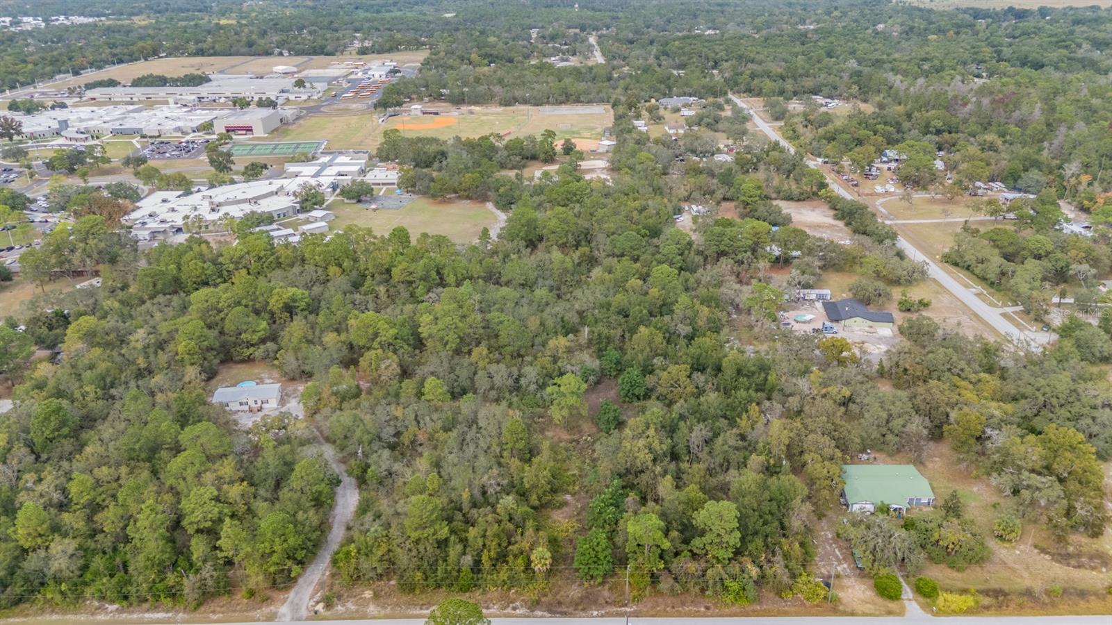 Here it is! JUST UNDER 5 ACRES Vacant Land High and Dry, backs up to Hudson School K - 12. Flood Zone X