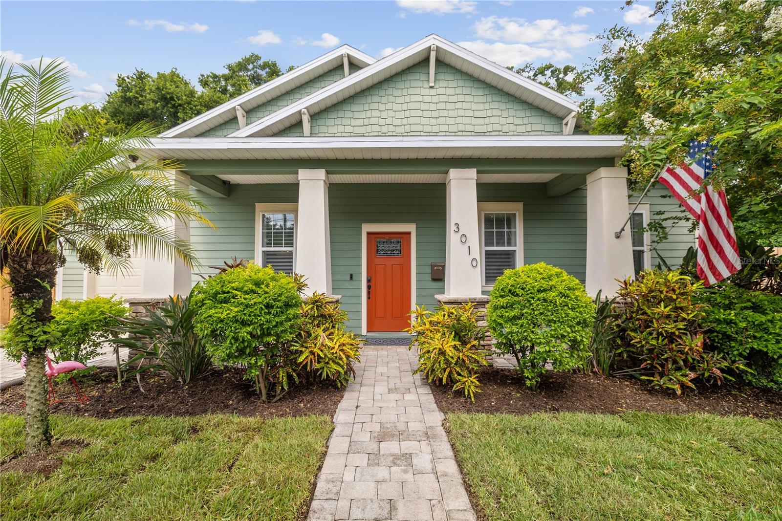 One or more photo(s) has been virtually staged. This gorgeous and newer-built three bedroom, two bath Tampa Heights bungalow is conveniently located less than one mile from Armature Works and the Tampa Riverwalk, and offers the charm of a classic home with the peace of mind of modern construction features and finishes.
Entering from the covered front porch into the expansive open living space, you’ll immediately notice hand-scraped engineered hardwood floors, soaring 10’ ceilings, plantation shutters and a functional gourmet kitchen featuring quartz countertops, with a separate custom coffee bar which provides tons of additional storage space and display shelves. The most discerning buyers will appreciate the attention to details found throughout, from the brass cabinet hardware, soft close cabinets, and built in drawers, to the high end light fixtures and touch-activated faucet.
The dining space features a glass bead chandelier and wainscoting with coat hooks, and the living room’s paneled wall provides a bold backdrop for a television to be mounted and connected to the room’s pre-wired surround sound system.
The primary suite is in the rear of the home, and features a French door to the paver patio, and a large primary bathroom that includes double vanity, large glass-enclosed shower, and a walk-in closet.
The two guest bedrooms are split from the primary suite, and include custom closets — one with a thoughtful storage solution and the other with a functional cozy desk space that could easily be converted back into a traditional closet.
Cuteness abounds in the guest bathroom, with timeless black and white tile, wood plank towel holders, and a shower/tub combo.
Across from the guest bath is the laundry room, practically arranged with upper cabinets refinished to match the kitchen, a clothes hanging bar, and a beautiful wood countertop for folding.
French doors from the living room lead to the spacious, well-shaded paver patio with cafe lights overhead and enough space for multiple furniture arrangements. The fully fenced yard also offers plenty of grass space for enjoying the private outdoors.
An extra-deep garage is a desirable bonus, and could be used for a workout and additional storage space in addition to parking a vehicle.
The property is adjacent to Plymouth Park, which the city plans to upgrade with brand new pickleball courts.
Additional features include impacted rated windows, a 2024 water heater, water softening and filtration system, hardwired security cameras and security system, and a Ring doorbell.