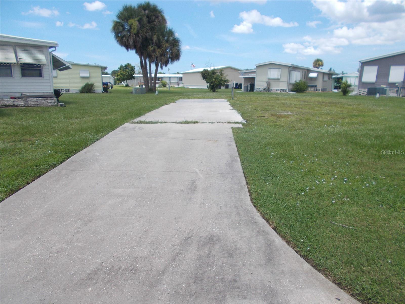 Vacant land in sought after Gated Community of Holiday Park, and in the Pet Section. In Holiday Park you own the land with a deed and the maintenance fee of $195.00 monthly ($2340.00 a year) is included in your taxes. This lot measuring 4662 sq ft. is in a cul-de-sac. The driveway has been left. Holiday Park offers many amenities including 2 Pools, Tennis Courts, Pickle Ball, Bocci, Shuffleboard, Laundry, Library, Tennis, Horseshoes, Bingo plus other card games, Fitness Room and so much more. This is a perfect place for your new manufactured home. Come and see!