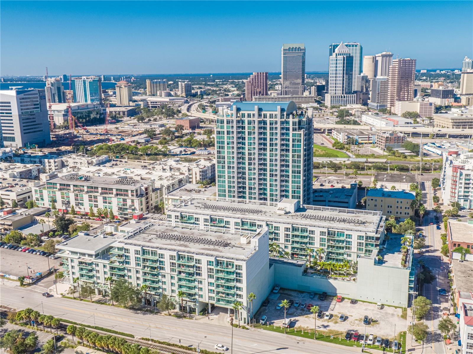 Located in the heart of Tampa’s Channel District. This 6th floor, 2 bed, 2 bath condo comes with two single parking spaces. The unit's upgrades include a newer AC system and water heater. Replaced the balcony sliders and screen, newer oven and cooktop with custom built-in storage in the kitchen area. Located on the 6th floor with a covered balcony, this spacious layout offers nearly 200 sq ft of private, glass-walled balcony space. From here, take in tranquil views of the cruise ships sailing into Port Tampa and sunrises with your east facing balcony. Step inside to a warm, modern interior with rich wood cabinetry, and sleek finishes throughout. The modern kitchen is ideal for entertaining, featuring granite countertops, a large center island, stainless steel appliances, and upgraded lighting. The master suite is a calming retreat, complete with a spacious walk-in closet. The en-suite bath includes light fixtures, dual vanities, granite counters, a soaking tub, and a frameless glass shower. Other upgrades include a biometric front door lock and hardwired ethernet in most rooms for lightning-fast connectivity. Live the resort lifestyle with access to a luxurious pool and hot tub surrounded by lush new landscaping, a newly renovated bar area, sauna, and a full fitness center. The building is pet-friendly and investor-friendly, with short- or long-term rentals allowed. Step outside and discover unbeatable walkability — from morning strolls past the Florida Aquarium and Tampa Riverwalk, to coffee at Shortwave Coffee Roastery, acai bowls at Fit Bowl Co, and dinner steps away at Bamboozle Cafe, Sparkman Wharf, or Water Street.