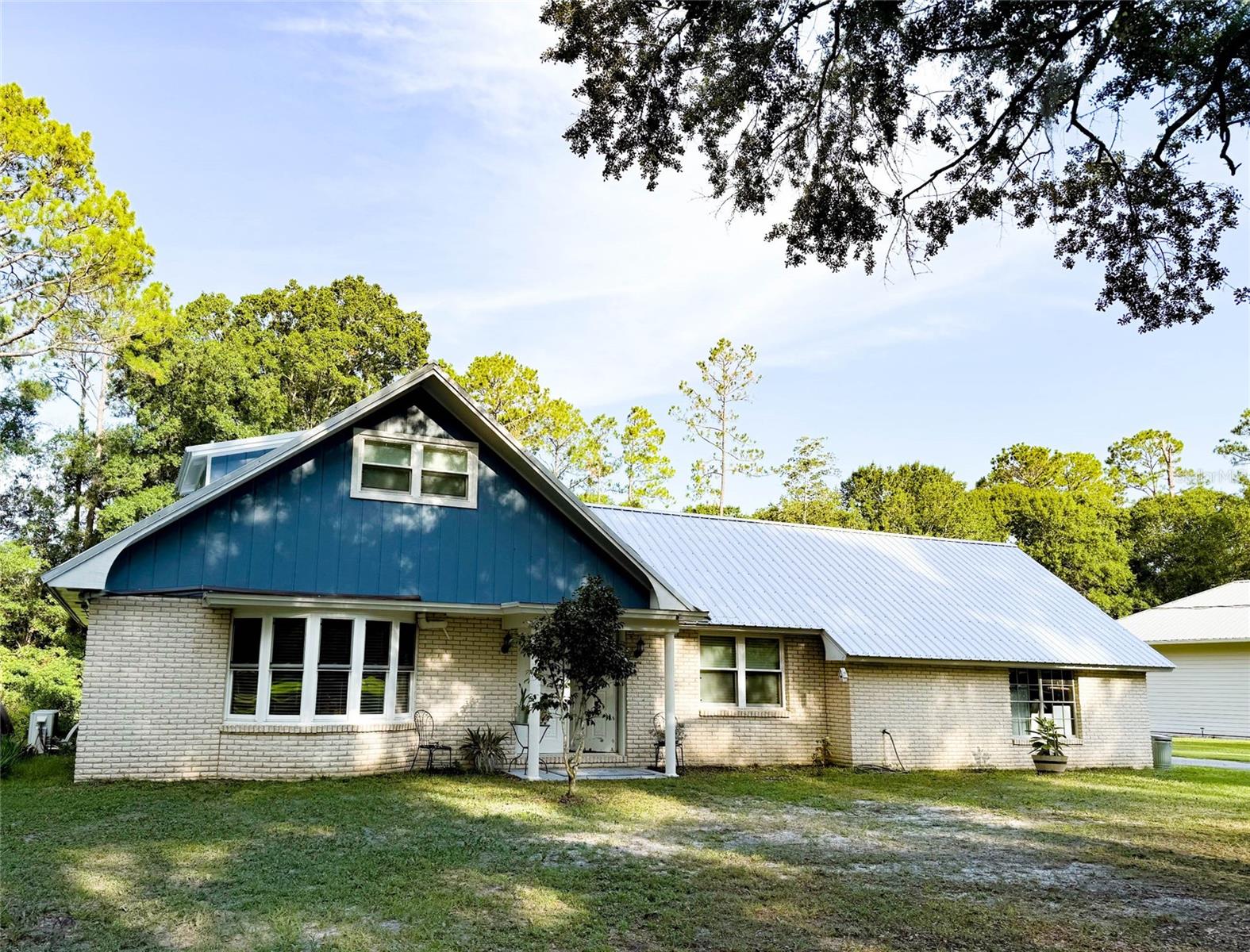 This 2 story, 4-bedroom, 2-bath home is nestled in an area near the Starke Golf & Country Club. With a two-year-old metal roof, windows installed in May 2024, water heater replaced in 2021, many big-ticket items are already in place. In addition there is a bathroom on each floor, attached garage and a fenced area for pets. Outdoors, you'll find a spacious lot with mature trees—offering both shade and charm. Inside, the home is a blank canvas awaiting your personal touch and vision. A great opportunity to create the home you've been dreaming of! Easy commute from Gainesville or Jacksonville.
