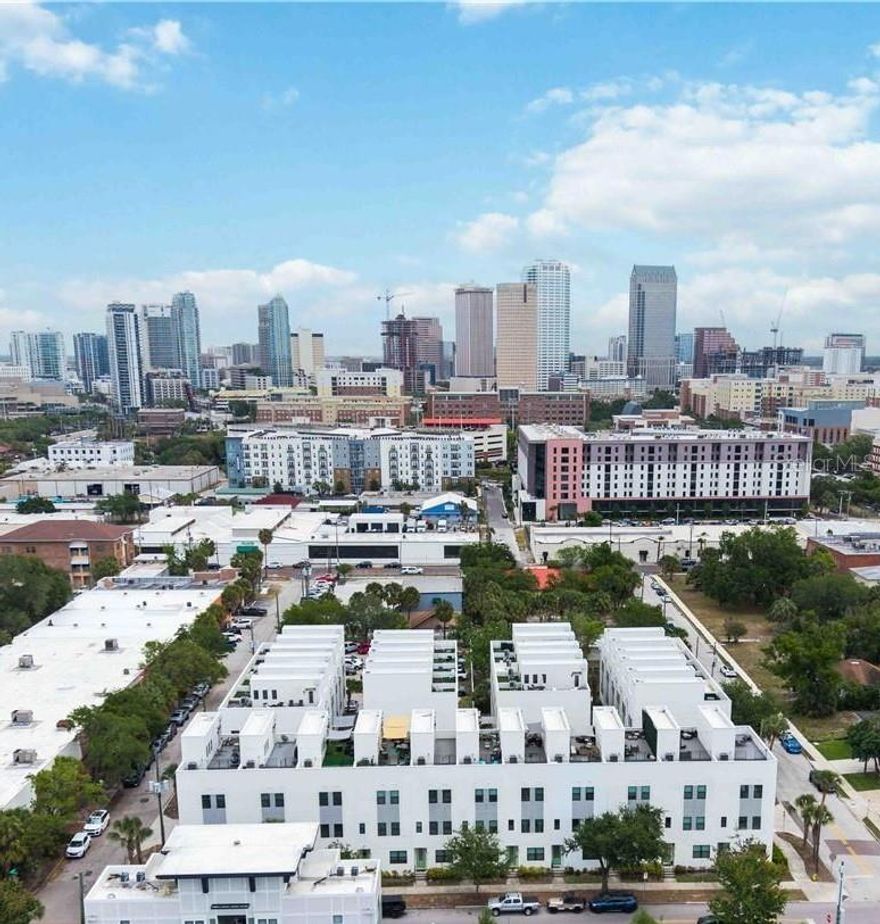 Presenting a rare opportunity to own a stunning residence in the Las Azoteas Townhomes Views at North Hyde Park! This downtown Tampa premier luxury townhome community is perfectly positioned within the highly coveted Plant High School district and the University of Tampa. Blending striking modern architecture with an unbeatable urban location, this home offers the ideal balance of style, comfort, and convenience in one of the city’s most dynamic neighborhoods.

Well maintained, this newer build townhome spans three spacious levels plus a private rooftop terrace, delivering a thoughtfully designed layout with two en suite bedrooms—each offering its own full bath for ultimate privacy and flexibility. Whether hosting guests, working from home, or maximizing rental potential, this versatile floor plan adapts seamlessly to your lifestyle.

Step inside to discover upgraded interiors highlighted by engineered hardwood flooring, expansive windows, and contemporary finishes throughout. The main living level is an entertainer’s dream, featuring an open-concept design with a chef-inspired kitchen complete with quartz countertops, soft-close cabinetry, stainless steel appliances, and a generous breakfast bar. Also, there is a dedicated dining space with a custom table and bench for you and a convenient powder bath to complete this level.

Upstairs, the primary suite serves as a tranquil retreat with a walk-through closet and a spa-like bath featuring dual vanities and a glass-enclosed shower. The second story has an office/bedroom with closet can be easily converted to a traditional bedroom and also features a centrally located laundry area with newer washer/dryer included to add everyday convenience. The first floor offers a bedroom—ideal for guests with its own attached full bathroom and easy access to the attached garage.

The crown jewel of this home is the expansive private rooftop terrace—an exceptional outdoor living space designed for relaxation and entertaining. Complete with a wet bar and mini-fridge, this one-of-a-kind rooftop offers unobstructed panoramic views of the Tampa skyline, creating the perfect backdrop for morning coffee, sunset gatherings, or evenings under the stars.

Located at the crossroads of Hyde Park, Downtown Tampa, and Tampa Heights, residents enjoy immediate access to Tampa’s most sought-after destinations, including the Riverwalk, Hyde Park Village, Armature Works, Julian B. Lane Riverfront Park, and the University of Tampa. Top-rated schools—Gorrie Elementary, Wilson Middle, and Plant High School—further enhance the home’s long-term value and desirability.

With its prime location, modern design, and strong investment potential, this exceptional townhome is more than just a place to live—it’s a lifestyle.  Schedule a showing today!