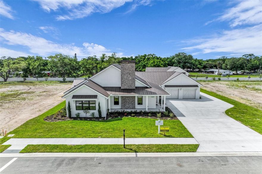 Under Construction. Now introducing a signature modern farmhouse in Paladin Estates, Sarasota’s newest private enclave designed for boat, RV, and collector car enthusiasts who value space, privacy, and high-performance living. Positioned on a premier half-acre homesite within this newly developed community, this custom residence pairs timeless farmhouse architecture with advanced durability and energy efficiency. Built as a true performance home, it features a standing seam 5V crimp metal roof, impact and insulated windows and doors, and open-cell spray foam insulation for superior structural strength, storm protection, and year-round climate control. Wide-plank European Oak flooring, architectural millwork, and custom built-ins add warmth and character throughout, while every closet is appointed with premium wood shelving. The chef’s kitchen anchors the home, crafted in partnership with Amish artisans and equipped with professional-grade Thor appliances, a Rohl Allia fireclay sink, custom cabinetry, and designer finishes for elevated everyday living and effortless entertaining. A detached 45-foot-deep toy garage with a 14-foot door delivers exceptional flexibility, accommodating an impressive classic car collection while the main residence provides two additional attached garage spaces. Alternatively, the structure is equally suited to house a large boat or RV with remaining capacity for stacked vehicles, creating a rare multi-purpose compound for serious collectors and outdoor enthusiasts alike. Outdoors, travertine surrounds a saltwater pool and spa, creating a resort-style retreat ideal for year-round Florida living, with additional backyard space offering the opportunity to add a private pickleball court or expanded recreational amenities. Just minutes from downtown Sarasota, the Cultural Coast, fine dining, championship golf, marinas, and the quartz-sand beaches of Siesta Key, this home by Yoder Built Properties stands as a statement of craftsmanship, integrity, and enduring quality. This property qualifies for a 1% lender incentive when using the preferred lender; inquire for details. Your Sarasota legacy starts here.