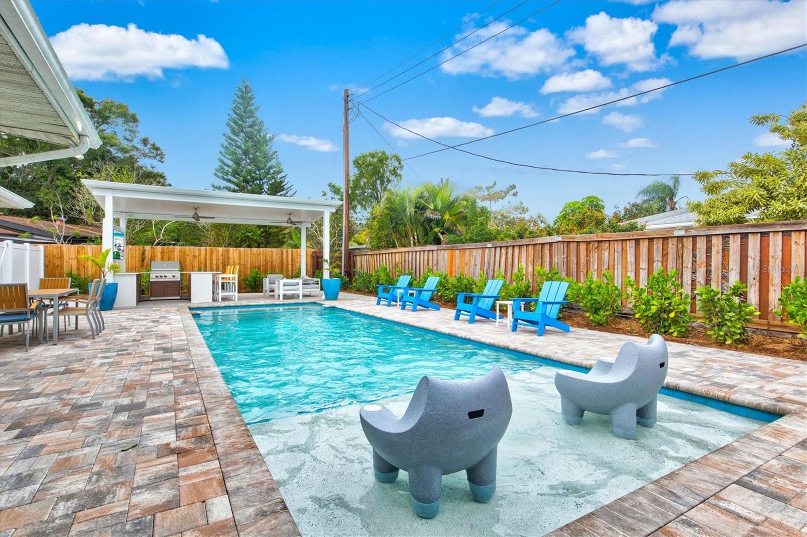 Turn-key Furnished with 38ft heated saltwater pool and spa, fully fenced yard, putting area and outdoor kitchen! Welcome to The "Retro Ringling" house, a unique designer home in downtown Sarasota with tons of modern amenities and nostalgic charm- all within a stone’s throw from Main St Sarasota, Payne Park and Legacy Trail & just a few short miles to the white sands of Siesta and Lido Beaches. There’s room for everyone in this 1954 built ranch style home with wide open floor plan and more natural light than any home you’re likely to visit. The Retro Ringling has a front to back living room with seating for 8 people and enormous Jalousie windows that capture the romance of the time. The house comes turn-key furnished! We've appointed the house in mid-century modern designer furniture while preserving the original terrazzo floors and custom tile work in the kitchen and baths. Our home is designed to transport you to a simpler time. Located on a quiet street in the historic Ringling Park neighborhood this home is classic, cozy and convenient. The living room centers around a 65 inch 4K Smart TV with ability to connect to Netflix, Amazon Video and other subscription services using our 200 mbps internet speed. Seating around the TV includes one leather couch, one upholstered queen sleeper sofa, 4 cushioned chairs and 2 bar stools. You will also find a vinyl record player with some classic albums, an oscillating Vornado fan as well as a retro bar stocked with board games and other goodies for all ages. There are 2 bedrooms and 2 full bathrooms as well as a separate cubby space that acts as a 3rd bedroom, (the Siesta Room) with a twin futon. All beds feature premium Lucid Mattresses and hotel grade bedding. The bed configuration is as follows:
Bedroom 1: 1 queen bed (Sleeps 2); 2 full beds (sleeps 2 adults or 4 kids)
Bedroom 2: 1 King bed (Sleeps 2)
Siesta Room (3rd Bedroom): 1 Twin bed (Sleeps 1)- Linens in Orange Cube next to bed.
Living Room: 1 Queen Sleeper Sofa (Sleeps 2)- Linens in hallway closet.
Both bedrooms have large empty closets with hangers as well as dresser space and nightstands with bedside lamps.
The Master bathroom offers a tub/shower combo and the 2nd bath is smaller with a walk-in shower. The eat-in kitchen will make you smile. There’s seating for 6 around a retro tulip table and and the beachy mint tile counters and backsplash set the stage for a brand new Big Chill 1950s style refrigerator with ice maker. There’s also a range/ oven, microwave, toaster over, spice rack, knife block set and coffee maker. The Florida room is spacious with a dining table for up to 8 people and a separate seating area with room for 6 more centered around a 50 inch 4K Smart TV on a swivel mount. This room is not air-conditioned however two ceiling fans provide some relief in the hotter months. This room also has a dart board and a cornhole set to be used out back.
Full laundry is available in the garage as well as an iron and ironing board and bench top for folding your clothes.
We have a large private, fenced back yard with brand new saltwater pebble tec pool and spa. The pool has also sunshelf with bubbler. There is a mini golf area, a cornhole area and a covered outdoor kitchen. Dogs are allowed with pre-approval and proof of flea/tick treatment.
The Retro Ringling offers the best of urban residential living with close proximity to all of the best restaurants and beaches but with room to spread out on a fully fenced private lot.