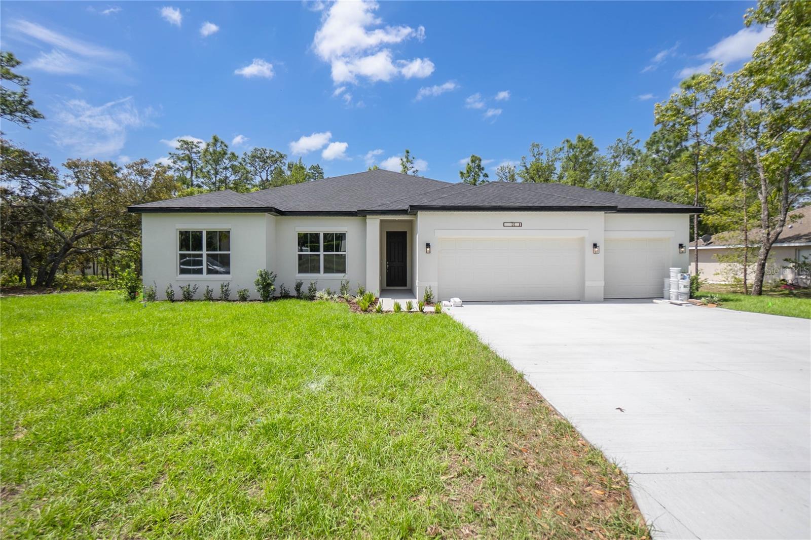 ABSOLUTELY GORGEOUS BRAND NEW 4 -bedroom, 3-bathroom home located in the beautiful community of Sugarmill Woods. Situated on a greenbelt for added privacy and natural views, this beautifully crafted residence offers 2,092 square feet of living and a spacious 3-car garage. SELLER OFFERING RATE BUY DOWN WITH PREFERRED LENDER. Designed with comfort and functionality in mind, the open floor plan features a gourmet kitchen complete with white wood cabinetry, quartz countertops, stainless steel appliances, an island, breakfast bar, and sizeable pantry—perfect for everyday living and entertaining. Additionally, the interior presents a split floor plan providing privacy, a primary suite offering a walk-in closet and an en-suite bathroom that includes dual sinks and shower, a combination of luxury vinyl plank flooring, tile, and plush carpet enhances the style and durability throughout. The interior laundry room is fully equipped with a washer, dryer, and folding area for convenience. The exterior features a covered lanai and a fully landscaped yard, ideal for enjoying Florida's year-round sunshine. This home is a perfect blend of modern finishes, practical design, and serene surroundings. The home is conveniently located minutes from shopping, amenities and the Suncoast Parkway. Call to schedule your tour!