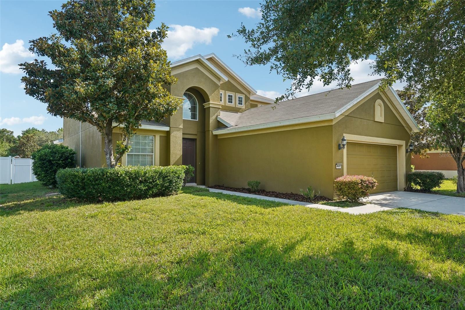 One or more photo(s) has been virtually staged. Welcome to this spacious two-story home in the desirable Cimarron community of Ocala, FL. Offering 4 bedrooms, 2.5 bathrooms, and 2,386 square feet of living space, this property blends comfort, functionality, and style. Step inside to a bright and open living room with soaring ceilings and large windows that flood the space with natural light. The living area flows directly into the kitchen, which features solid wood cabinetry, a center island, stainless steel appliances, and an adjacent dining nook. You’ll also find both a two-panel and three-panel sliding glass door, allowing for easy access to the backyard and plenty of indoor-outdoor connection. A separate formal dining room offers flexibility for additional entertaining space, a home office, or creative use. The main-floor primary suite includes a walk-in closet and an en suite bathroom with dual sinks, a soaking tub, and a separate shower. Upstairs, a spacious loft provides a second living area, while three additional bedrooms offer plenty of room for guests, hobbies, or everyday living. Outside, enjoy a fenced-in backyard perfect for relaxing or entertaining. Cimarron residents have access to a community clubhouse, pool, fitness center, basketball, tennis, and pickleball courts. Conveniently located near hospitals, restaurants, shopping centers, and the Ocala International Airport, this home offers both comfort and convenience in a vibrant neighborhood. Don’t miss the opportunity to make this exceptional property your next home. Mortgage savings may be available for buyers of this listing.