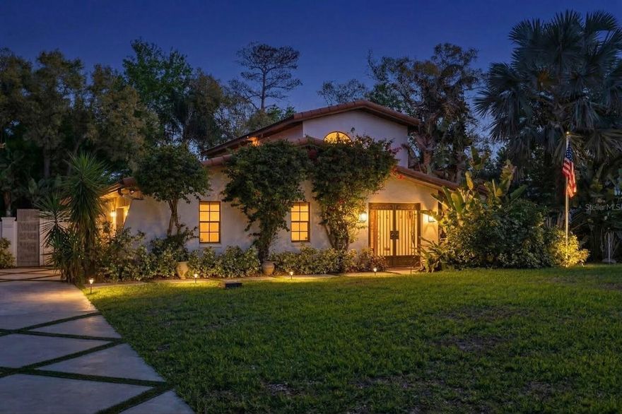 Welcome to La Bella Villa.

Some homes reveal their beauty slowly. Others captivate the moment you arrive.

Set on a lush tropical half-acre, La Bella Villa welcomes you through a graceful wrought-iron courtyard entry, a serene, shaded space that evokes a private retreat. Framed by vibrant bougainvillea, it introduces a home where every detail has been considered, from materials to the way light flows through the spaces.

Inside, authentic Mexican clay Saltillo tile floors extend throughout the main living areas, grounding the home in warmth and timeless charm. Talavera tile accents bring artistry and color, while decorative ceiling tiles above the kitchen and dining area introduce texture and refinement.

The gourmet kitchen is the heart of the home, featuring custom rustic pine cabinetry, open shelving, stainless steel appliances, and a hand-hammered copper sink that serves as both a focal point and a work of art.

The main level features a secret hidden door, an element of intrigue and architectural detail, which conceals access to the primary bedroom retreat and a second generously sized bedroom, ideal for guests or a home office, along with two full bathrooms. Upstairs, two additional bedrooms share a full bathroom, with one opening onto its own screened patio, offering a peaceful spot for morning coffee or evening breezes.

Outside, La Bella Villa transforms into a resort-style oasis. An oversized screened patio overlooks a sparkling pool, brick paver deck, fire pit, and a peaceful hammock lounge nestled among lush tropical landscaping.

Homes offering this level of craftsmanship, charm, and resort-style atmosphere rarely come to market. La Bella Villa is more than a residence; it is a secluded Mediterranean-inspired escape in the heart of Tampa.