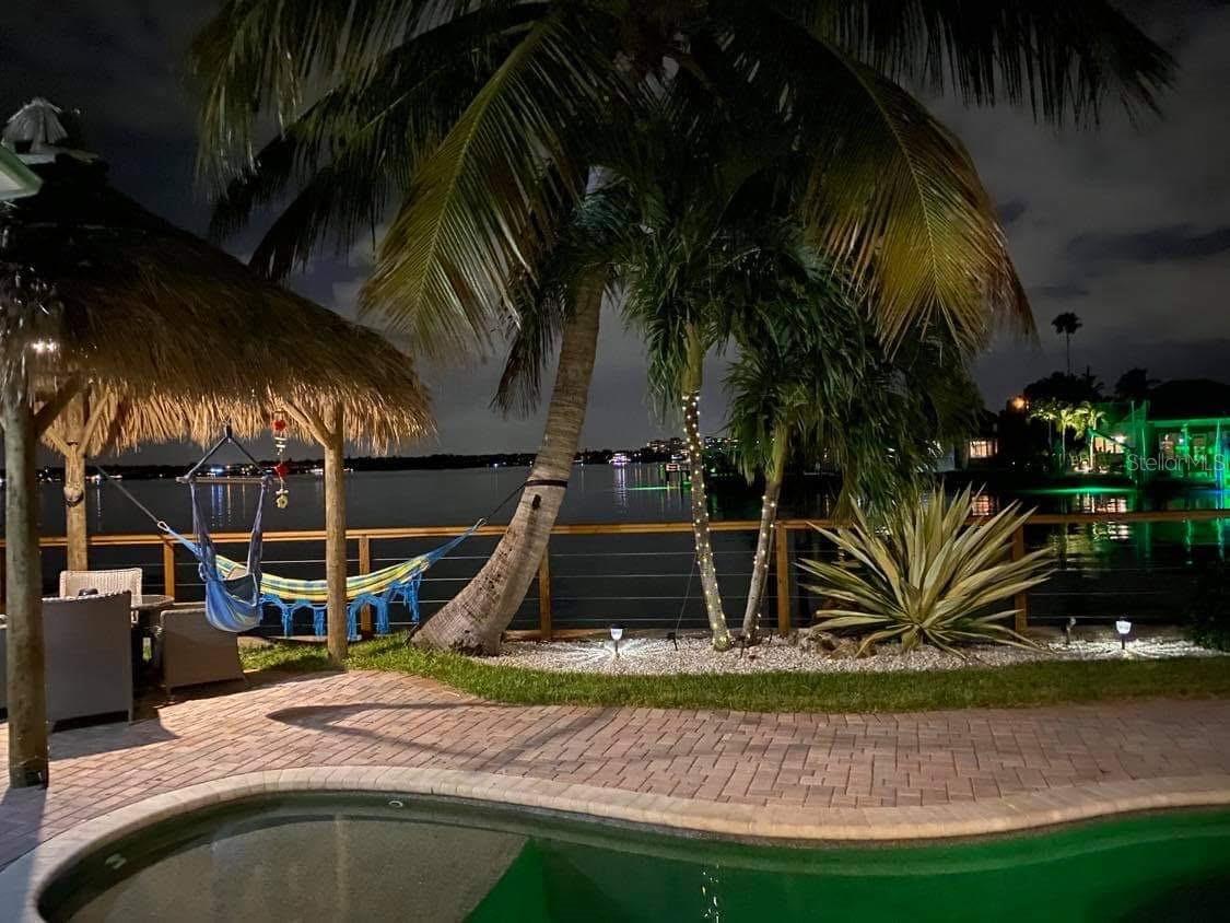 LOCATION IS EVERYTHING...If you are looking for BREATH TAKING UNBELIEVABLE VIEWS with EXPANSIVE OPEN WATER VIEWS of the INTRACOASTAL..THIS IS IT. This 3 bedroom 2 bath, SPLIT FLOOR PLAN is located on one of the most beautiful lots in Redington Beach. The home experienced damage from hurricane Helene giving you the opportunity to repair or redevelop, adding your personal touches to make it your own. ***THIS PROPEERY HAS BEEN DEEMED NOT SUBSTANTIALLY DAMAGED****Significant upgrades have already been done...NEW ROOF 2023, NEW DOCK 2024 WITH A 10000 LB BOAT LIFT. The home oozes with Ole SOUTHERN FLORIDA CHARM, staring with the expansive front porch, to the open floor plan that has 3 sets of FRENCH DOORS all leading out to a magnificent pool area where you will enjoy countless hours of relaxation and entertaining, sitting under your Tiki Bar, entertaining your friends and family. The seller has a current appraisal which significantly raises the value for the FEMA 50% rule. Call to schedule your showing today