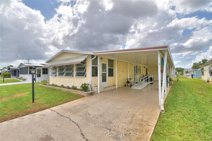 Your new Florida home is waiting for you.  This home has many updates and improvements.  The shingled roof was installed in December 2024 and the HVAC is 6 years old.  A new vapor barrier has been installed.  There are new plywood subfloors and luxury vinyl plank in the living room, dining room, hall, and both bathrooms.  There is no carpet in this home.  The kitchen is perfect for preparing all those special meals.  The living room is open and spacious.  The front Florida room is perfect for your morning coffee.  Lake n Golf Estates, a 55+ community,  offers many amenities including a pool, shuffleboard, and clubhouse.  Join in the activities or just sit back and enjoy the peaceful community.