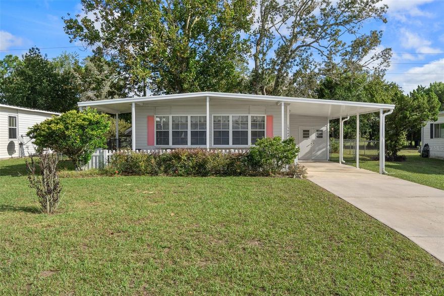 This charming and very well maintained, partially furnished two bedroom home features open and bright kitchen, dining and living areas. Spacious master bedroom with half bath. New laminate flooring throughout. Bathrooms have new sheetrock walls and tile flooring. Amazing Florida Room and spacious utility room. FENCED BACK YARD. METAL ROOFOVER. Vapor barrier reinforced approximately 1-2 years ago. Enjoy the community pool, tennis, shuffle board, golfing, countless activities & organizations. Just minutes from medical facilities, shopping & restaurants. All of this with low HOA fees and YOU OWN THE LAND!