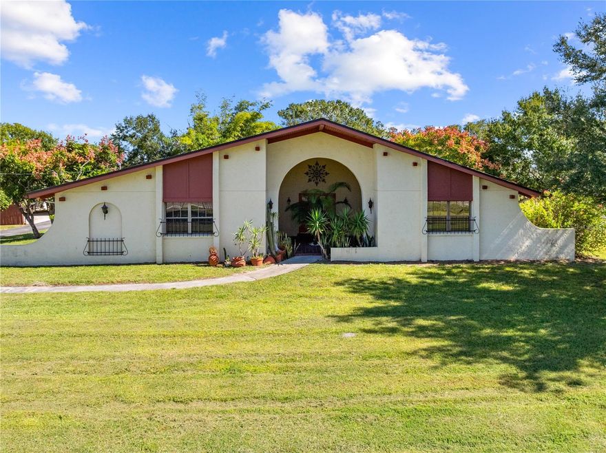 One or more photo(s) has been virtually staged. Welcome to your private retreat in St. Cloud! This distinctive Spanish-inspired home sits on a full 1-acre lot at the end of a quiet dead-end street, offering the perfect blend of charm, space, and convenience. Showcasing timeless character through its arched entryways and warm interior featuring oversized rooms and two cozy wood-burning fireplaces, it exudes both comfort and craftsmanship. The home has been beautifully updated with new carpet, a new roof, newer A/C, and a brand-new double oven, dishwasher, and microwave. The kitchen is stylish and functional, complete with stainless steel appliances, a smooth cooktop, abundant counter and cabinet space, and a movable center island for flexible use. A bright sunroom extends the living area, overlooking the expansive, fully fenced backyard, which is a perfect spot to relax or entertain. Outdoor enthusiasts and hobbyists will love the impressive oversized metal building of more than 1,000 square feet, equipped with A/C, a roll-up door, and a separate electric meter, ideal for hobbies, storage, vehicles, or even a motor home. Two additional storage sheds and an oversized 2-car garage add even more functionality. Enjoy the freedom of country living with room for animals or gardening while staying just minutes from the Turnpike, giving you quick access to Orlando, the beaches, theme parks, and the airport. Nearby, explore Lake Tohopekaliga and East Lake Toho for boating and fishing, or spend a day at Royal St. Cloud Golf Links, all while being close to shopping, dining, medical facilities, and quality schools. Offering space, privacy, and convenience rarely found together, this property is a true St. Cloud gem ready to welcome you home!