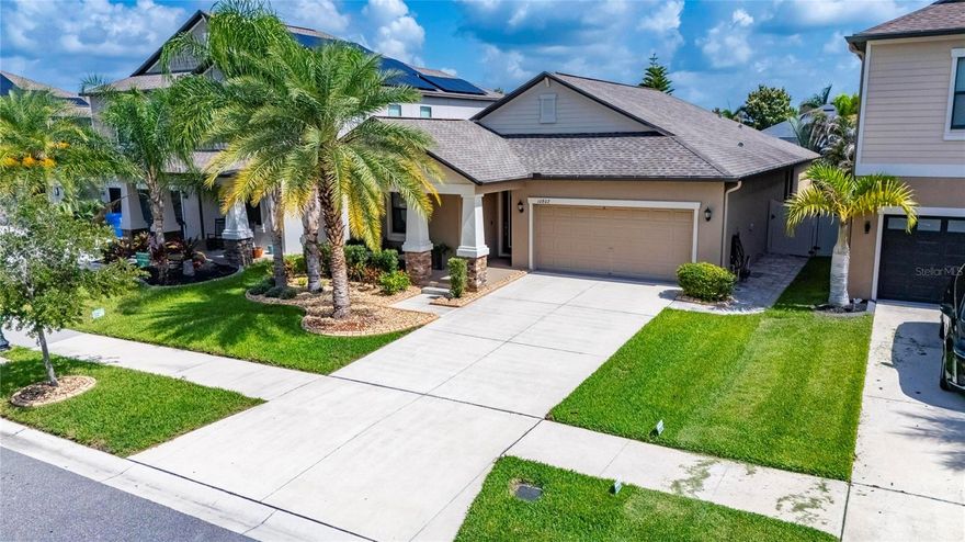 Welcome Home to this impeccably maintained 4-bedroom, 3-bathroom home located in the peaceful Oaks at Shady Creek community! From the moment you arrive, you’ll notice the exceptional curb appeal with meticulously maintained landscaping, an inviting front porch, and a home that truly shows like a model. 
Step inside and prepare to fall in love with the bright, open-concept layout featuring elegant tray ceilings, crown molding, custom window shades and drapes, and tasteful upgrades throughout. Beautiful ceramic tile flooring flows through the main living areas, while upgraded luxury vinyl plank flooring adds warmth and style to all bedrooms.
The beautifully designed kitchen is the heart of the home and showcases stunning Quartz countertops, tall cabinetry, a spacious pantry, and new appliances (February 2026) including an induction range, making it as functional as it is beautiful.
The spacious living and dining areas are ideal for both everyday living and entertaining, while the smart home wiring and whole-home water softener add modern convenience and comfort.
Retreat to the oversized primary suite featuring a large walk-in closet and a luxurious en-suite bathroom complete with dual granite vanities, a relaxing garden tub, separate walk-in shower, and private water closet.
Step outside to your screened-in lanai with an extended patio area — the perfect space to enjoy your morning coffee, entertain guests, or simply soak up a little Florida sunshine. The fully fenced backyard provides additional privacy and room to relax, play, or entertain.
Residents of Oaks at Shady Creek enjoy great amenities including a community pool, fitness center, playground, and basketball court. Even better, the HOA includes full lawn maintenance services, including mowing, fertilizing, trimming, and general landscape care — giving homeowners more time to relax and enjoy the Florida lifestyle. Conveniently located near US-301 and I-75, you’ll enjoy easy access to shopping, dining, entertainment, amazing beaches, and everything the Tampa Bay area offers.
This home is truly move-in ready and an absolute must-see. Schedule your private showing today!