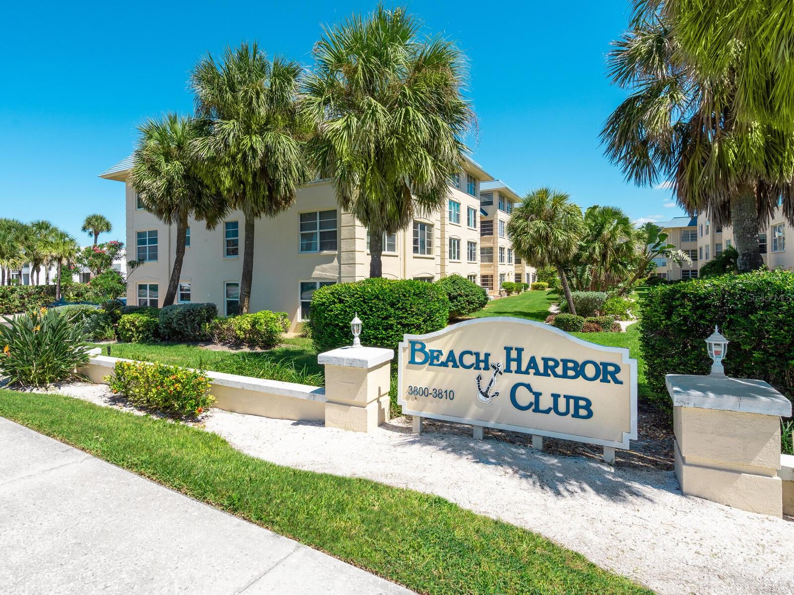 Beach Harbor Club is a beautifully maintained Gulf-to-bay community offering boat slips on the bay and private beach access on the Gulf side. Just bring your bathing suit and flip flops as this two-bedroom and two-bath unit has been beautifully updated to include an all-new bright open kitchen with custom cabinetry, stone counters and high-end appliances, including a Fisher & Paykel fridge, a two-drawer Cafe dishwasher, and a Cafe two-oven, six-burner stove. Flooring throughout was updated with a light blond luxury vinyl plank. Both baths had updates including cabinetry and countertops found in the kitchen. The AC was replaced in 2024. This home also has a sweet view of the Gulf from the outdoor seating area in the front. Beach Harbor Club is an active and amenities-rich community with boat docks, a pool, a gym, private beach access, kayak storage, a ground-level storage closet for beach gear, a beautiful clubhouse and just upstairs from this unit is a wonderful rooftop deck for sunset viewing.
