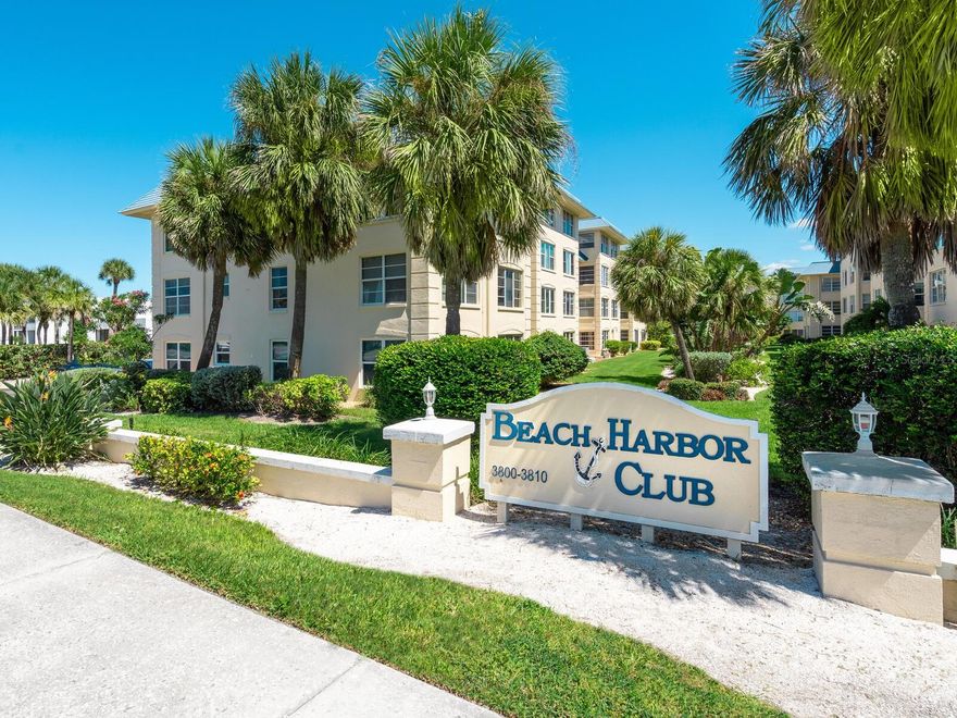 Beach Harbor Club is a beautifully maintained Gulf-to-bay community offering boat slips on the bay and private beach access on the Gulf side.  Just bring your bathing suit and flip flops as this two-bedroom and two-bath unit has been beautifully updated to include an all-new bright open kitchen with custom cabinetry, stone counters and high-end appliances, including a Fisher & Paykel fridge, a two-drawer Cafe dishwasher, and a Cafe two-oven, six-burner stove. Flooring throughout was updated with a light blond luxury vinyl plank. Both baths had updates including cabinetry and countertops found in the kitchen. The AC was replaced in 2024. This home also has a sweet view of the Gulf from the outdoor seating area in the front. Beach Harbor Club is an active and amenities-rich community with boat docks, a pool, a gym, private beach access, kayak storage, a ground-level storage closet for beach gear, a beautiful clubhouse and just upstairs from this unit is a wonderful rooftop deck for sunset viewing.