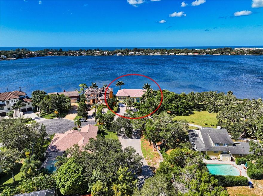 PRICE REDUCED TO $3,199,000!  This luxury water front home with full bay views is a hidden gem.  It is tucked away on a cul-de-sac, south of the Stickney Point Bridge in Buccaneer Bay.     As soon as you enter this majestic home, there are sweeping views of Little Sarasota Bay from the entrance and the main living area.  There is not a single room in this house that does not boast sweeping Bay views.  Don't mess with hurricane shutters.  This home has new (2023) impact windows throughout.  The sliding doors open to a large deck overlooking the bay and your private dock.  The two master bedrooms upstairs can be accessed by stairs or by elevator.  The master suites open to a spacious second floor deck overlooking the Bay and beyond Siesta Key.  There is a bonus room on the 2nd floor that could serve as a 4th bedroom.    The first floor has an incredible kitchen with center island, bar and breakfast area, which of course have full Bay views.  The expansive living area is 20' x 29' with a dedicated 16' x 14' dining area which is open to those gorgeous views.  The ceilings sweep up beyond the second floor.  There is a full bedroom and private bath on the 1st floor and a 16' x 18' study overlooking those gorgeous Bay views.  Bring your boat to the private dock right outside your door.  Words cannot describe spotting the dolphins and birds from the this sun drenched home, decks and dock.