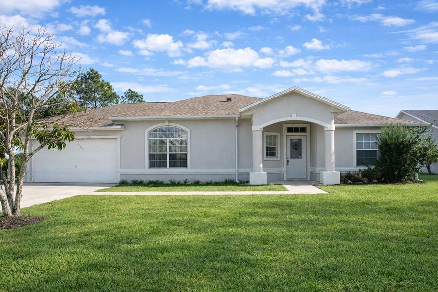 One or more photo(s) has been virtually staged. Located in the desirable Indian Trails neighborhood of Palm Coast, 3 Burne Place offers comfort, convenience, and a great location close to everything. This 4-bedroom, 2-bathroom home features 1,588 square feet of living space and sits on a quiet cul-de-sac, providing a peaceful residential setting. Inside, the home showcases high vaulted ceilings that create a bright and open feel throughout the main living areas. The living room features sliding glass doors that lead to a screened-in lanai, perfect for relaxing or enjoying Florida’s year-round outdoor lifestyle. With tile and laminate flooring throughout the home, there is no carpet, offering both style and easy maintenance. The split floor plan provides privacy, with the primary suite featuring dual closets and a full bathroom with convenient access to the garage. Three additional bedrooms offer flexibility for family, guests, or a home office. Outside, the spacious yard provides plenty of room to create your own outdoor retreat, garden, or play area. Conveniently located near top-rated schools, shopping, restaurants, parks, and walking trails, this home is also about 20 minutes from Flagler Beach, allowing you to easily enjoy Florida’s beautiful coastline. Whether you're searching for a primary residence, first home, or investment opportunity in Palm Coast, 3 Burne Pl offers location, space, and value in a well-established community.